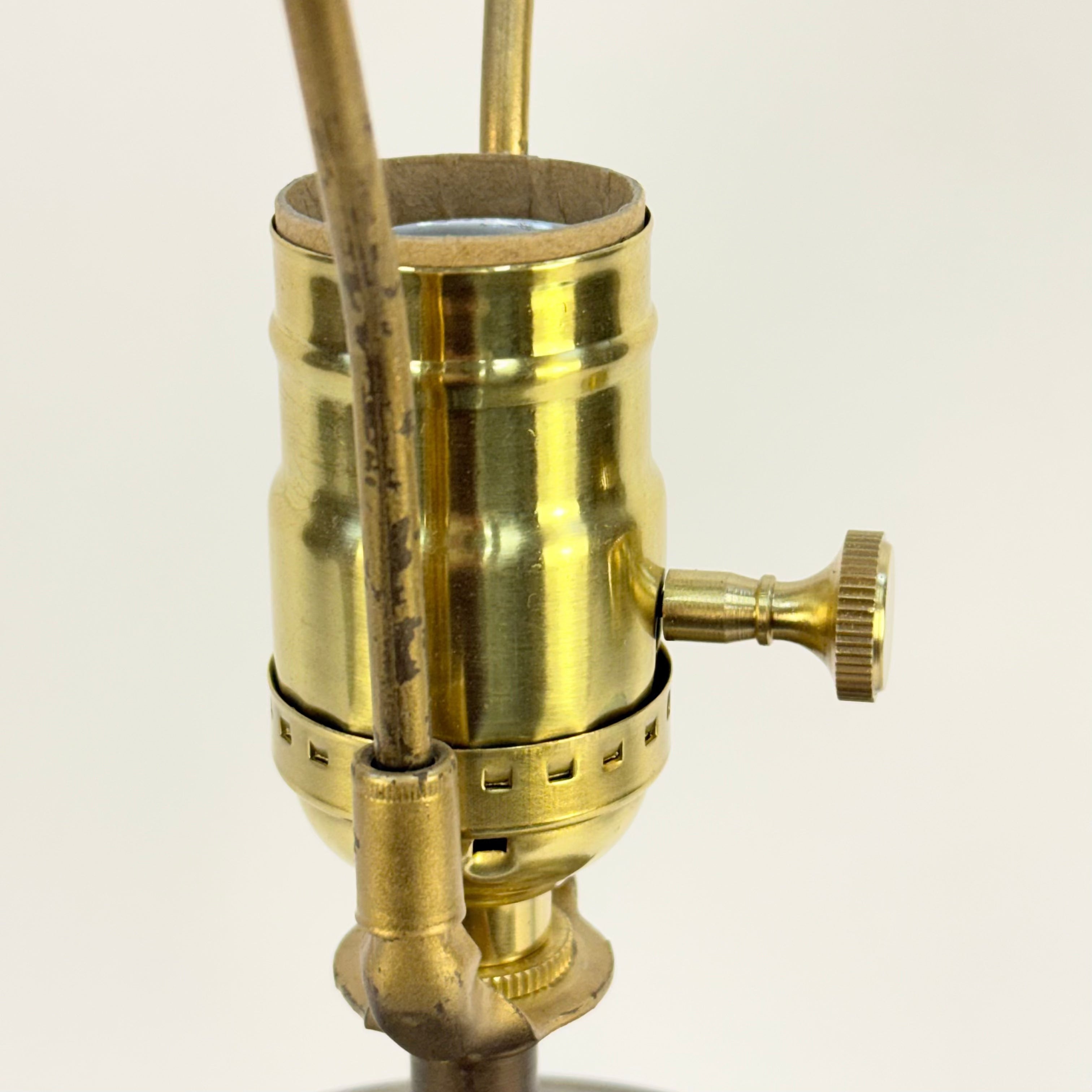 Brass lamp fitting on a white background