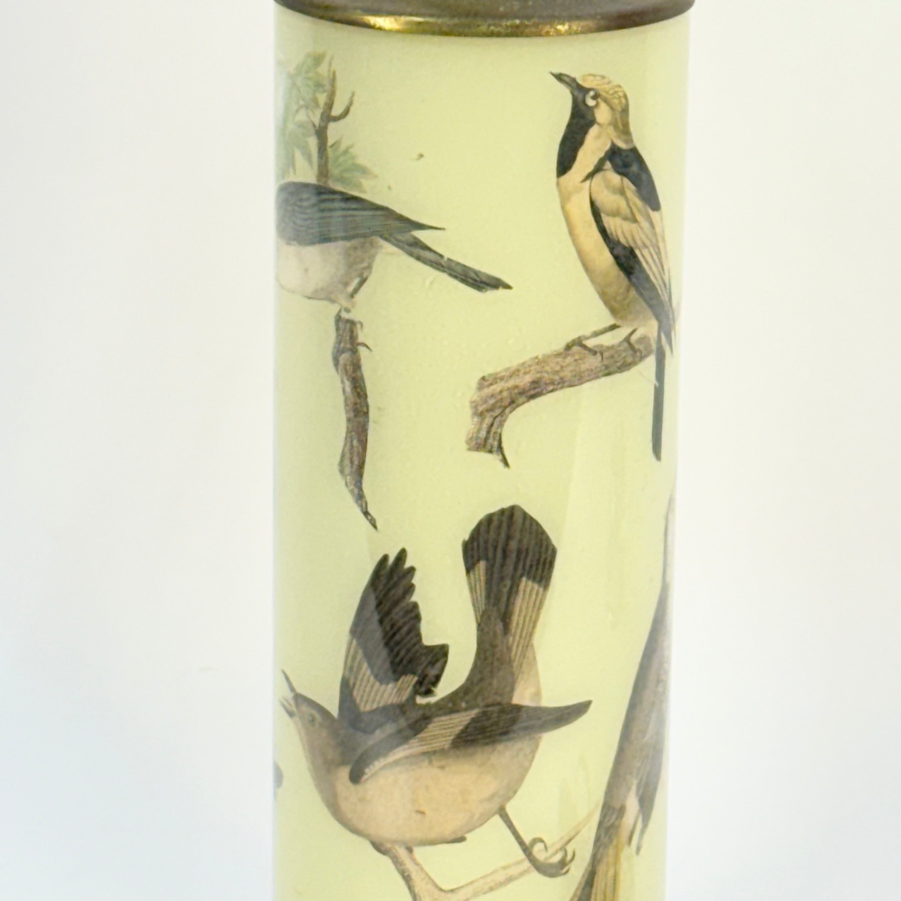 Cylindrical container with bird illustrations on a beige background