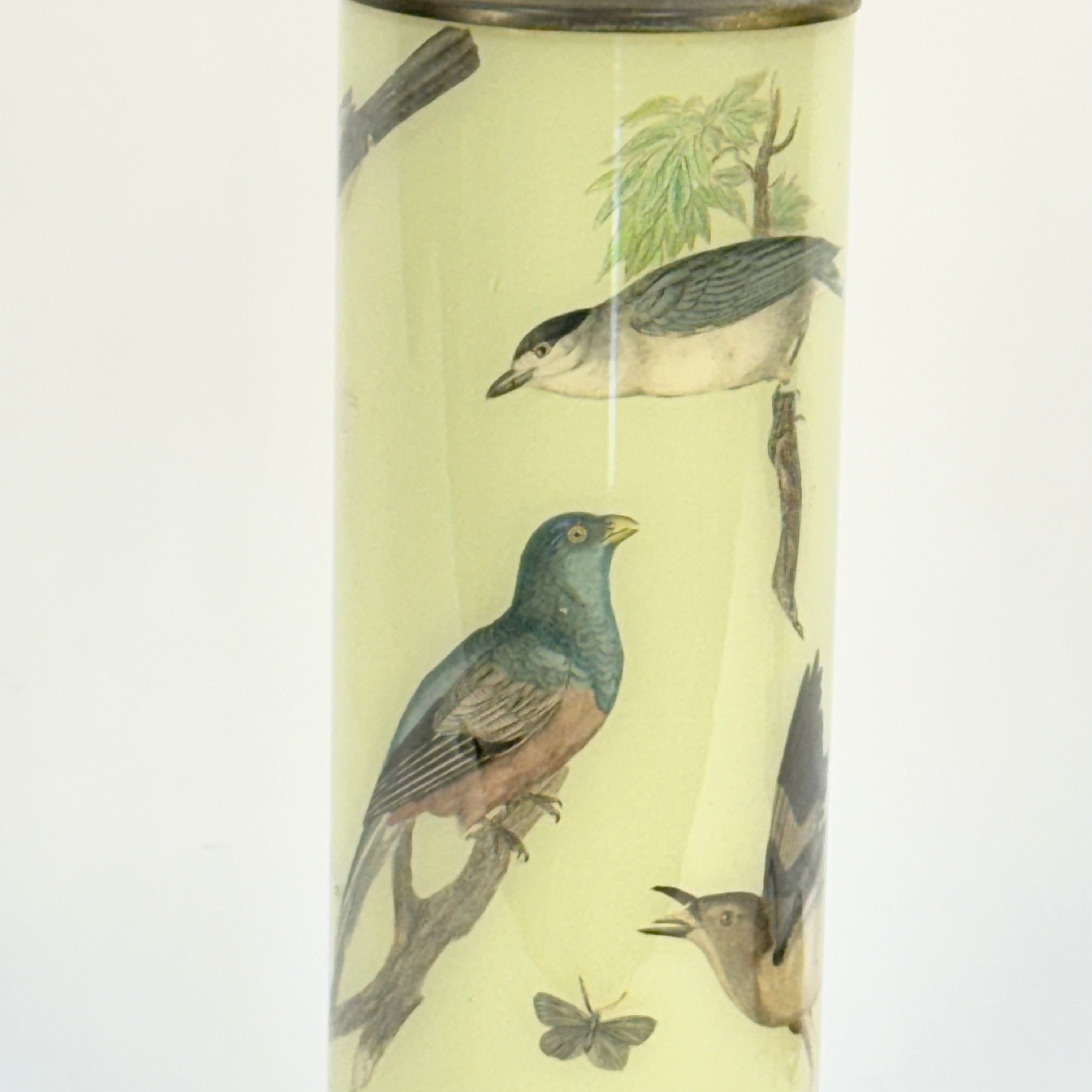Tall cylindrical container with bird illustrations on a light background