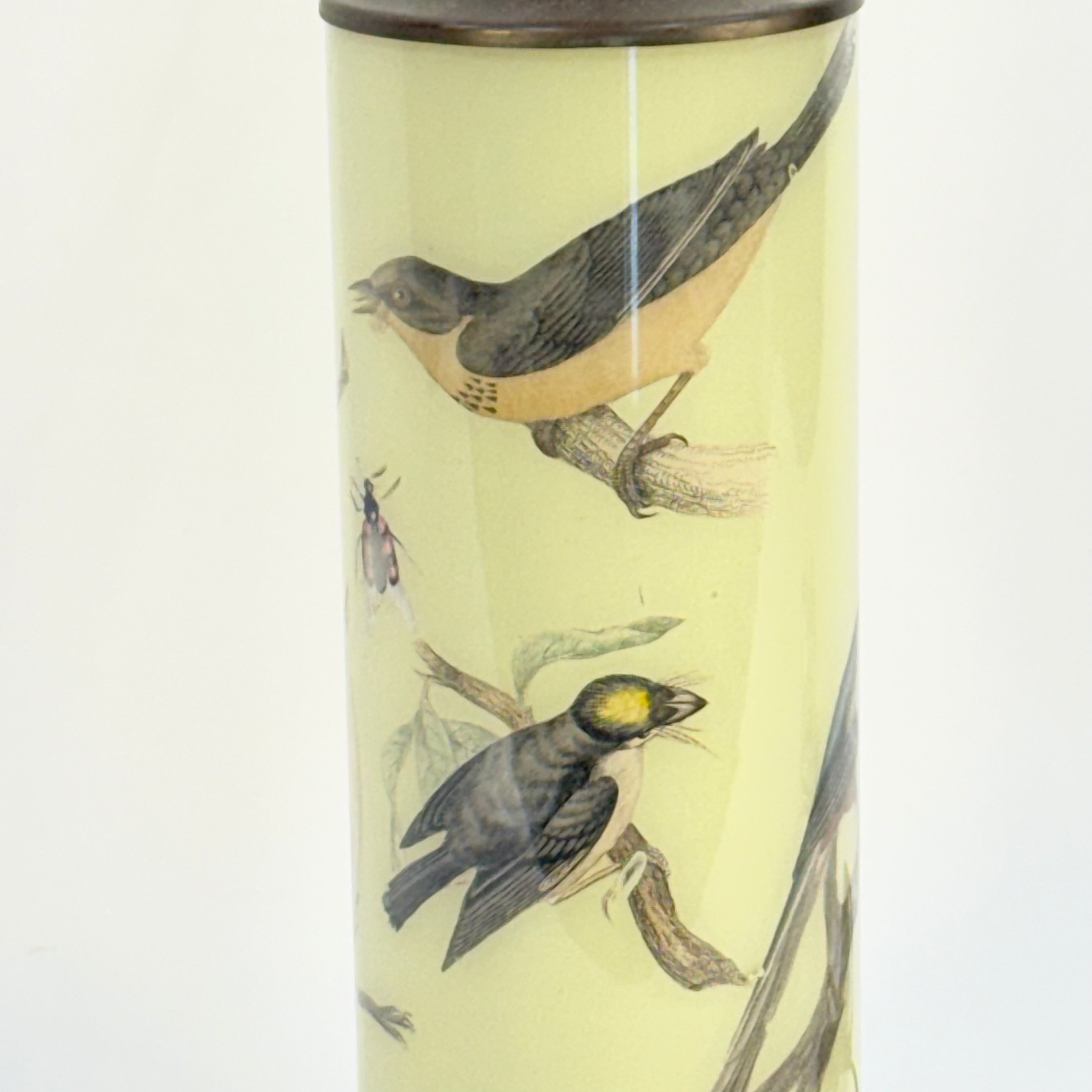 Tall cylindrical container with bird illustrations on a light yellow background