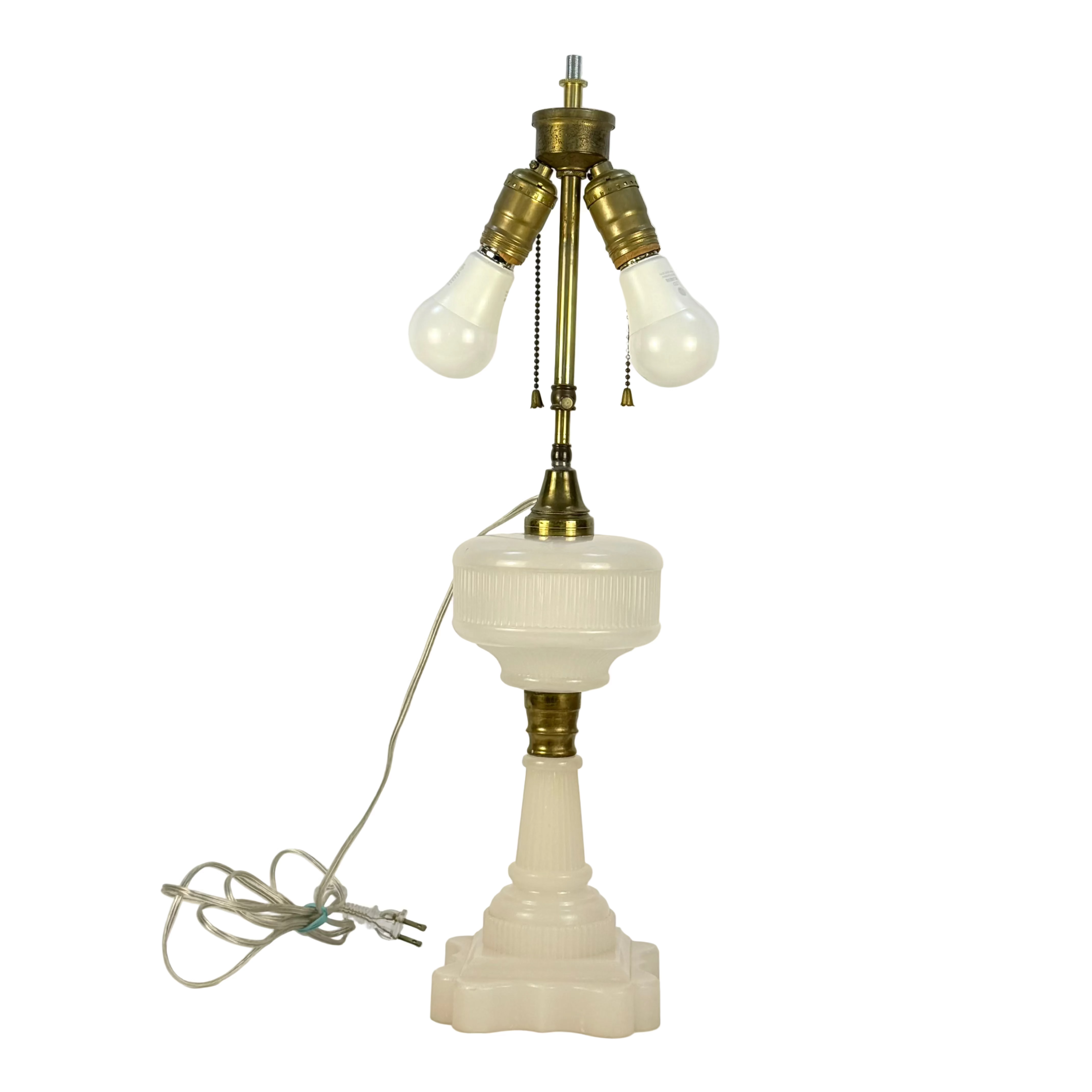 Vintage-style table lamp with brass accents and white glass on a light gray background