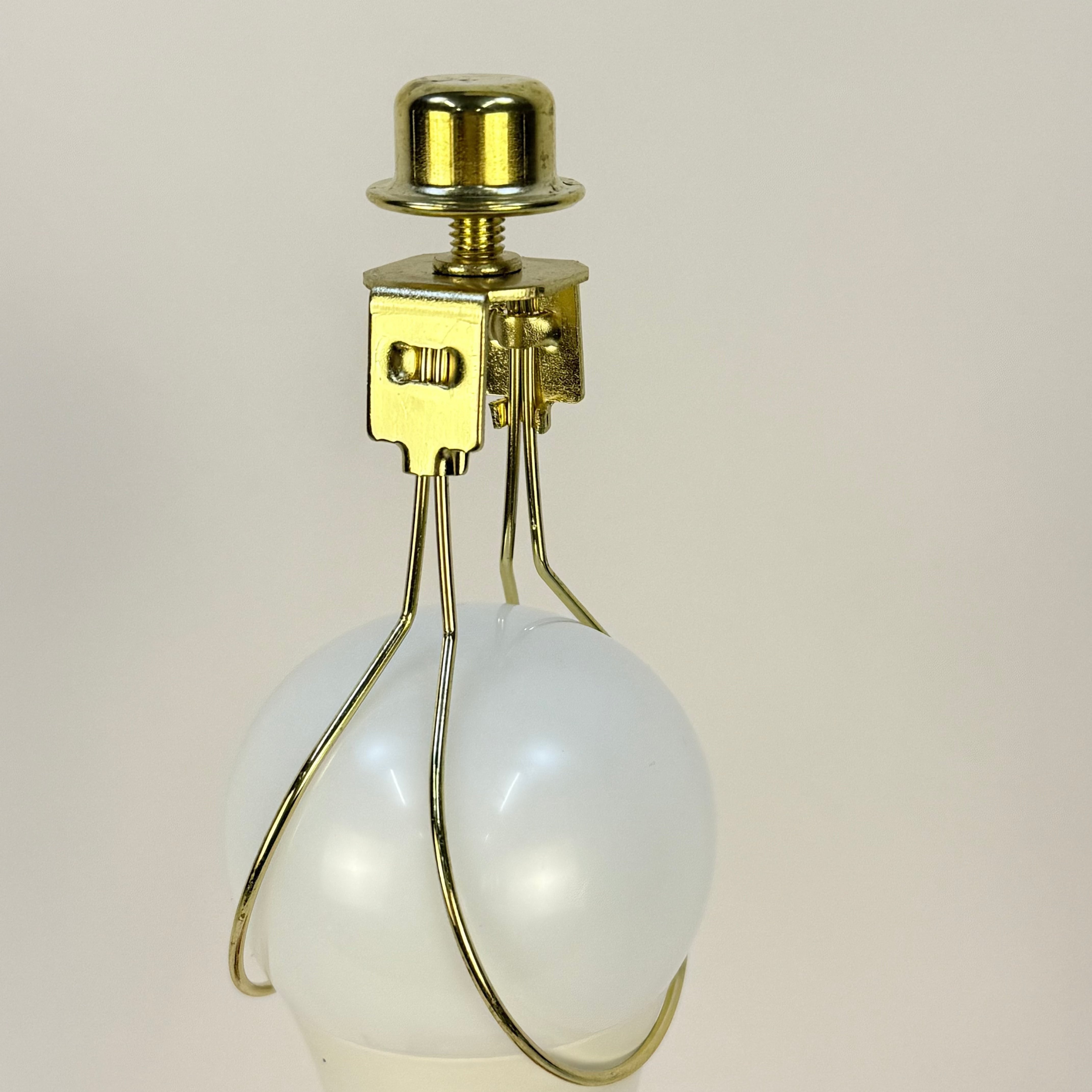 Vintage-style light bulb with gold fixture on a beige background