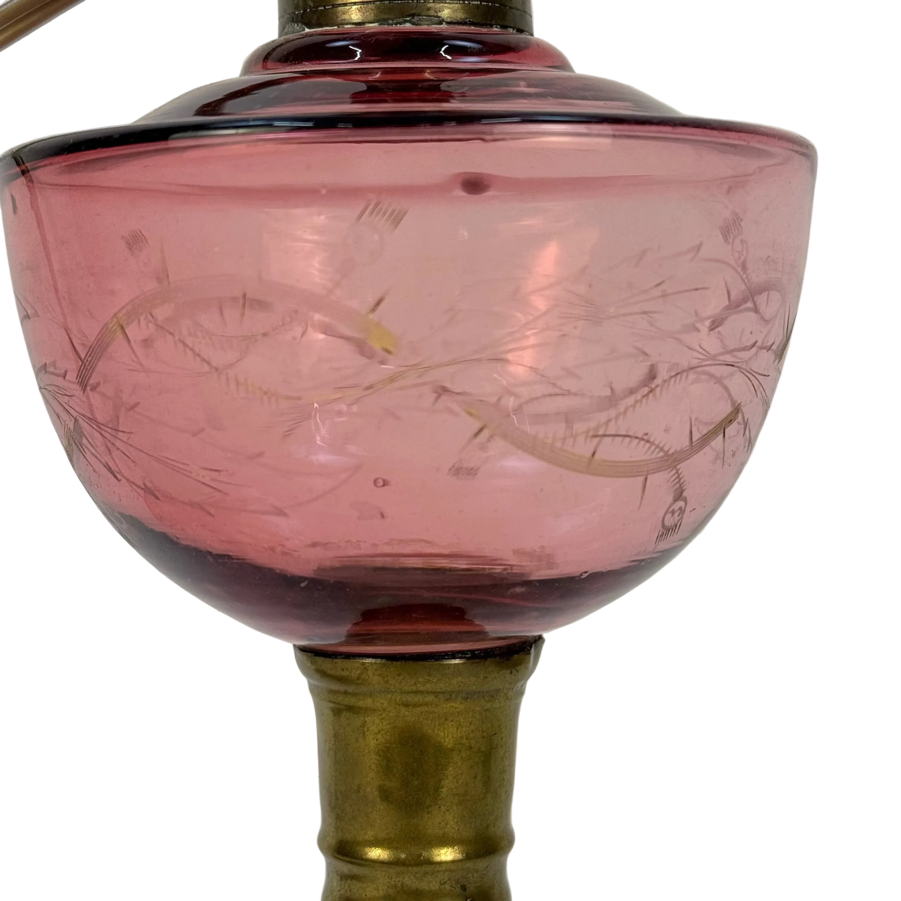 Pink glass lampshade with engraved design on a white background