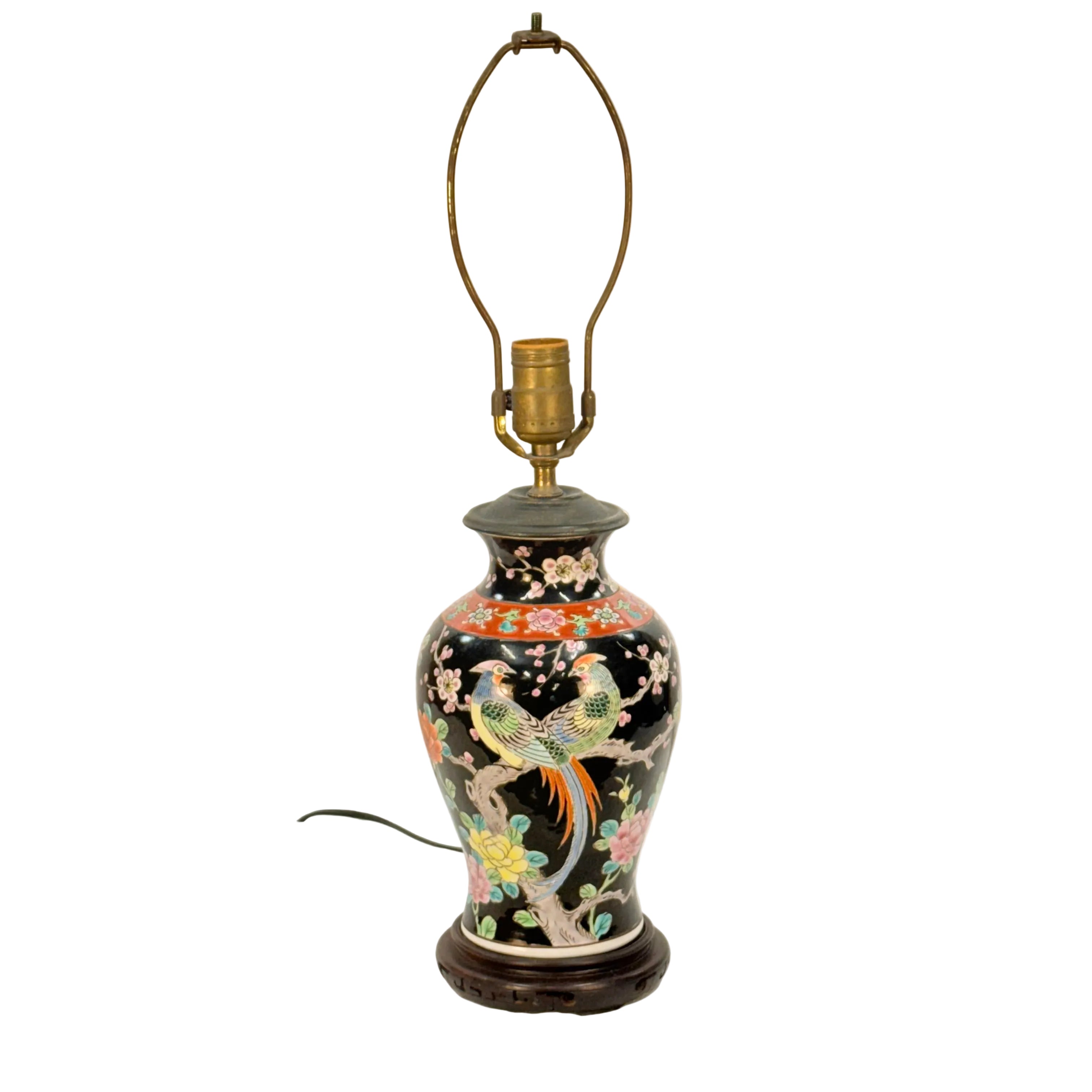 Decorative table lamp with floral and bird design on a plain background