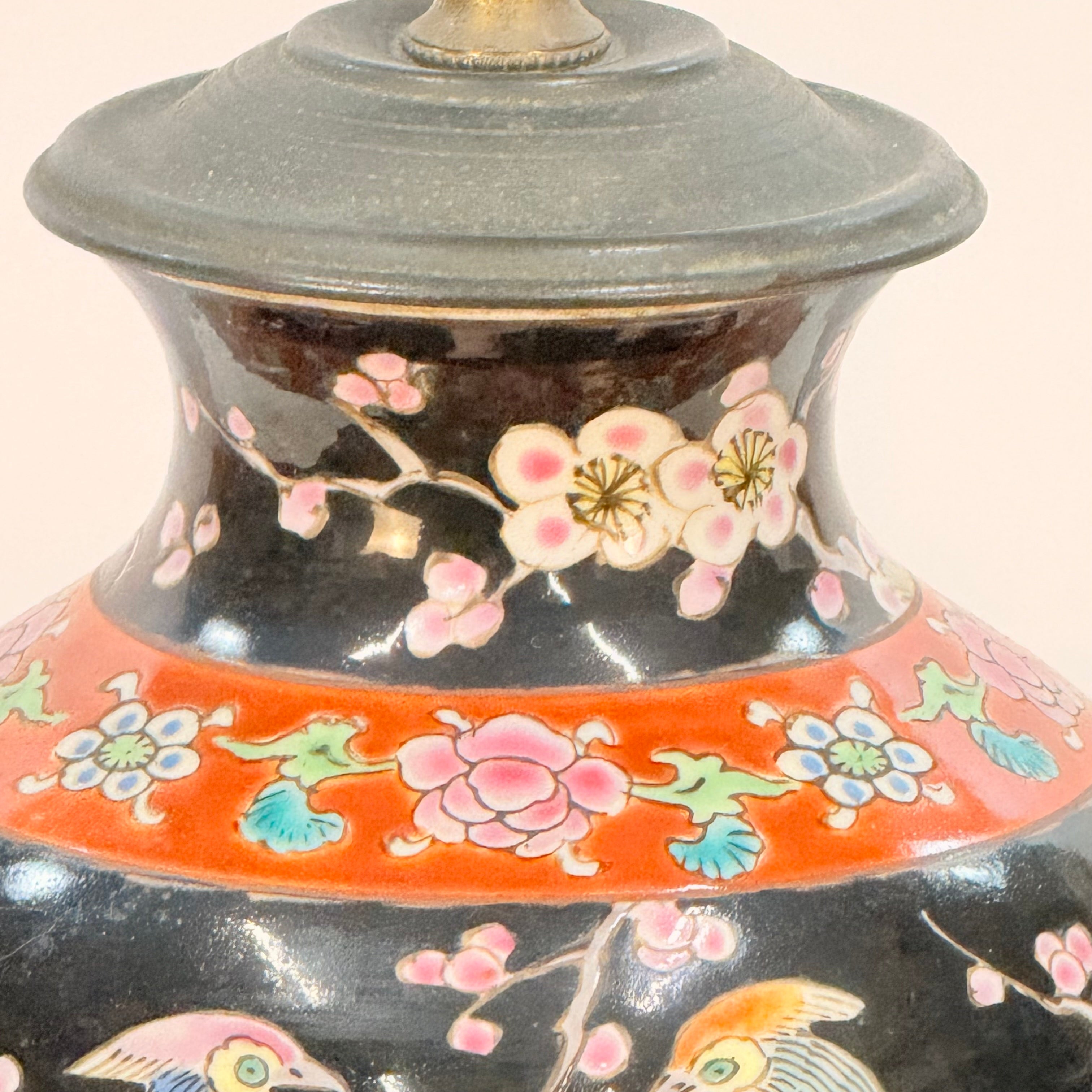 Decorative ceramic lamp with floral patterns on a plain background