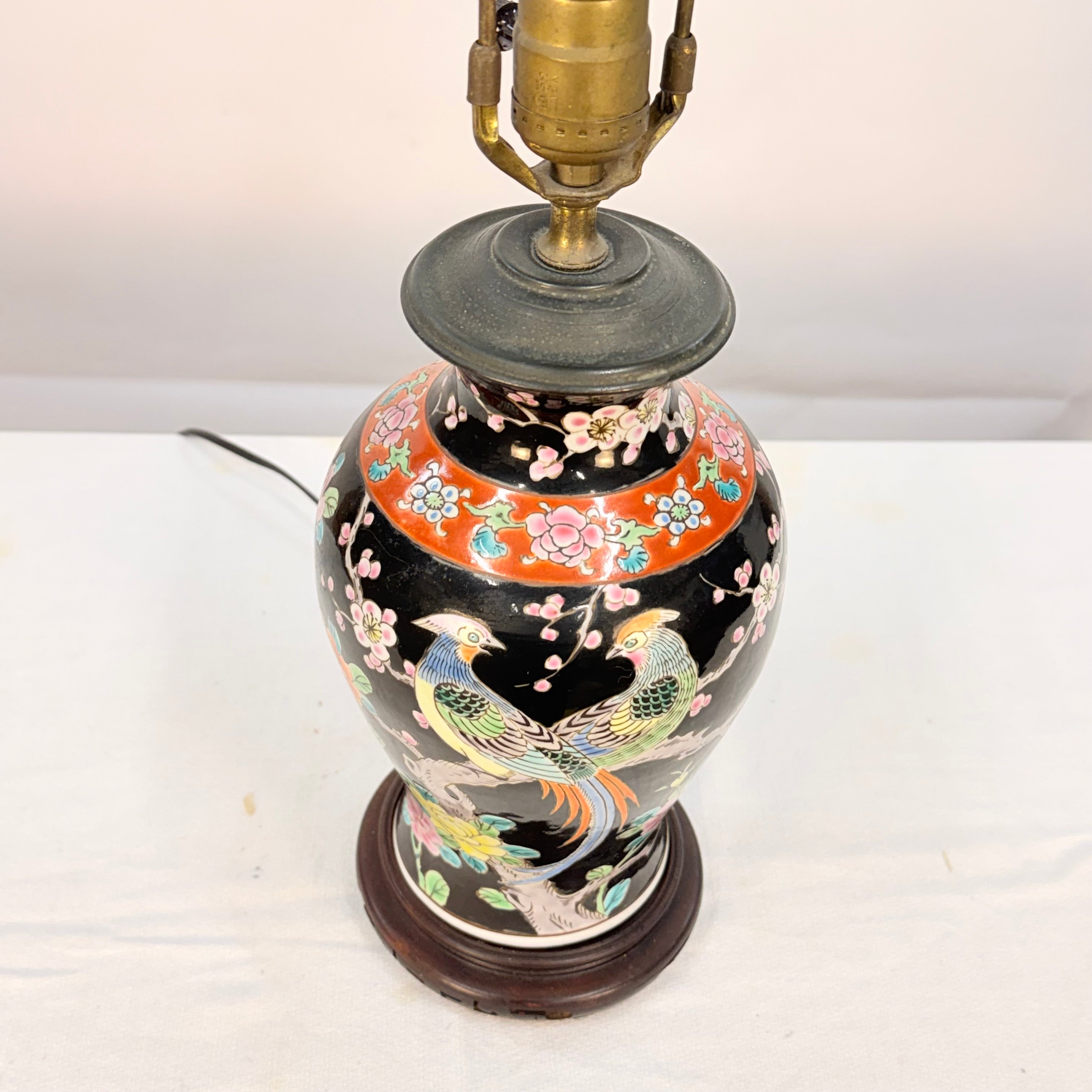 Decorative lamp with floral and bird design on a white background