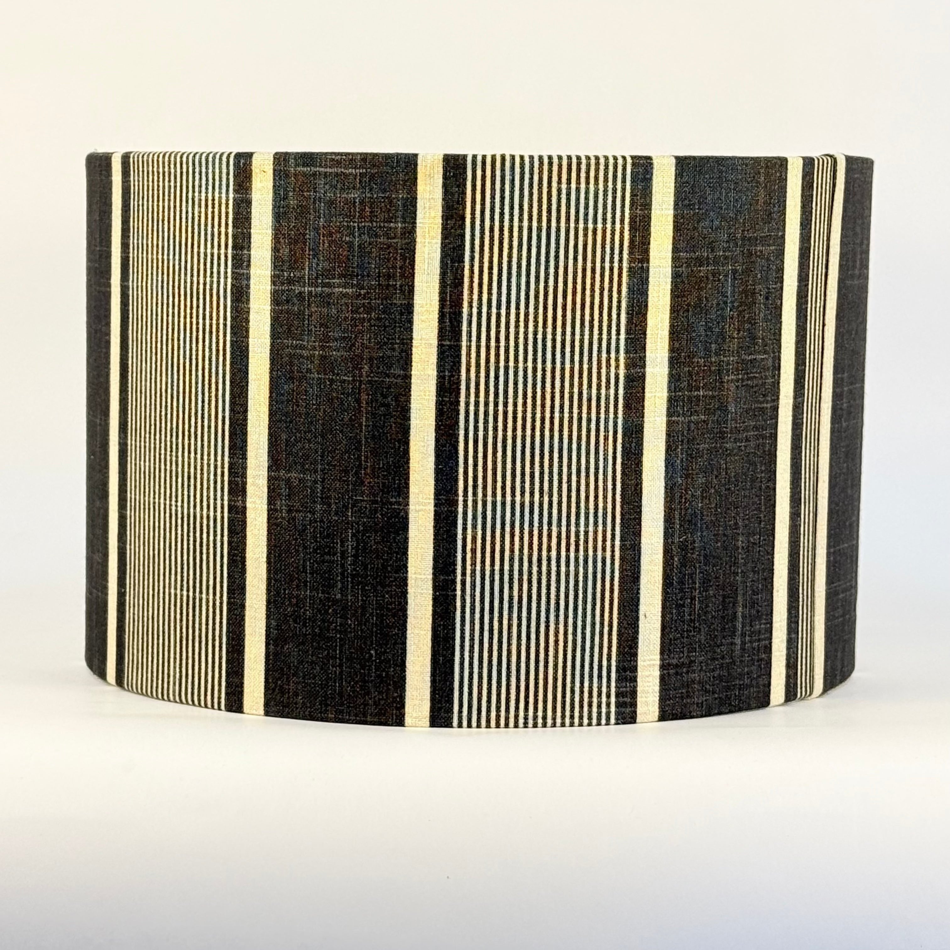 Striped lampshade with black and beige pattern on a white background
