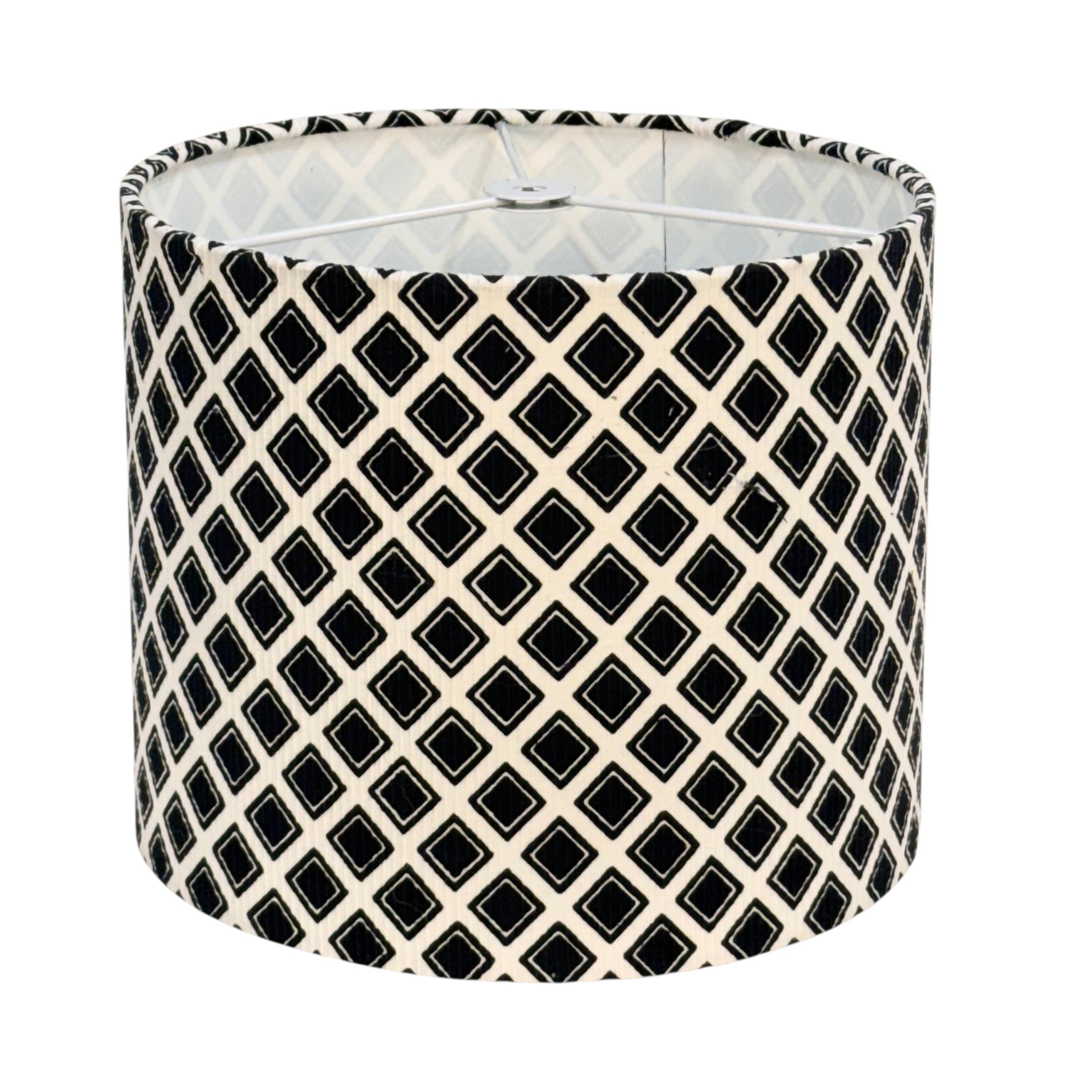 A drum lampshade featuring a black and cream geometric diamond lattice pattern, shown against a plain white background.