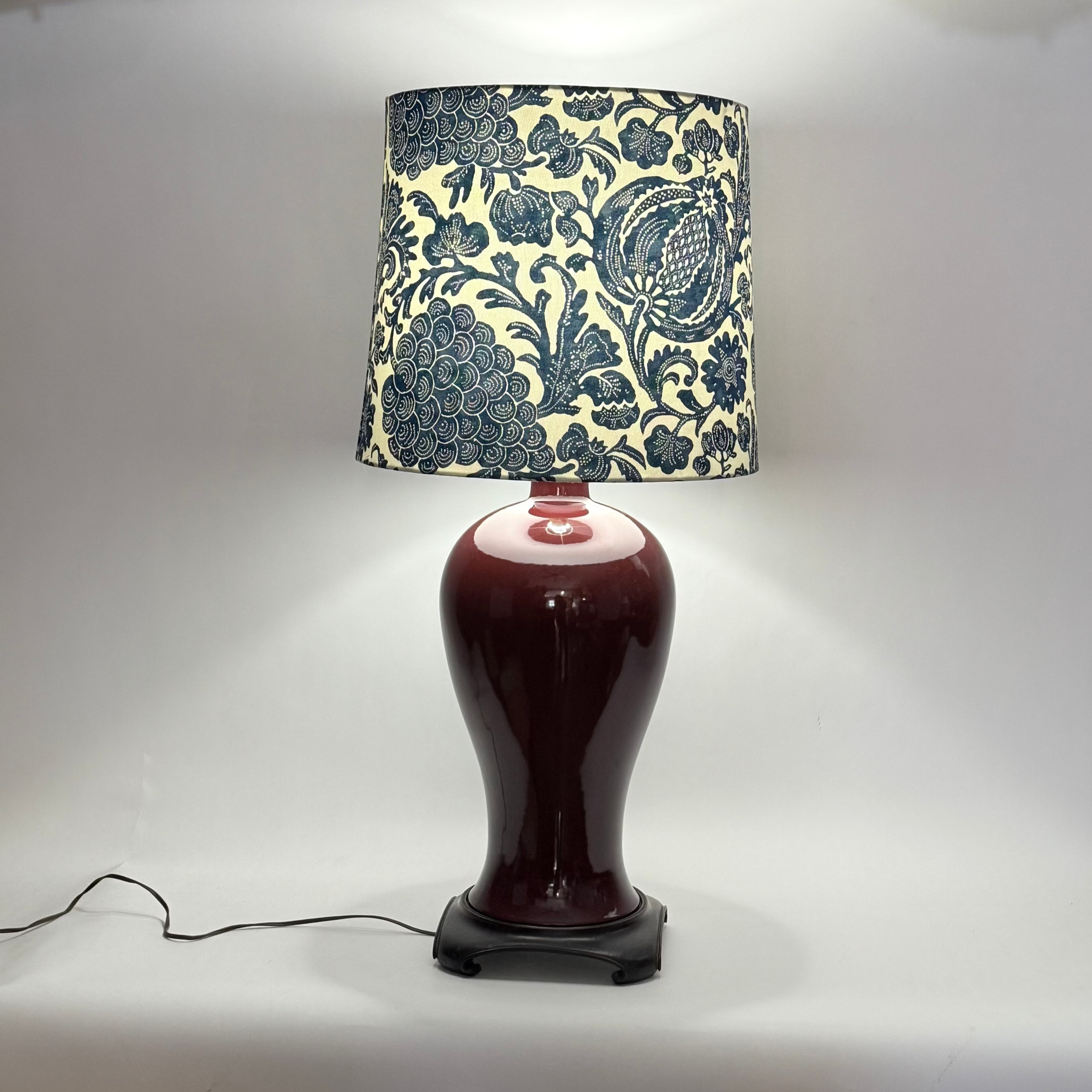 Decorative lamp with a patterned shade on a white background
