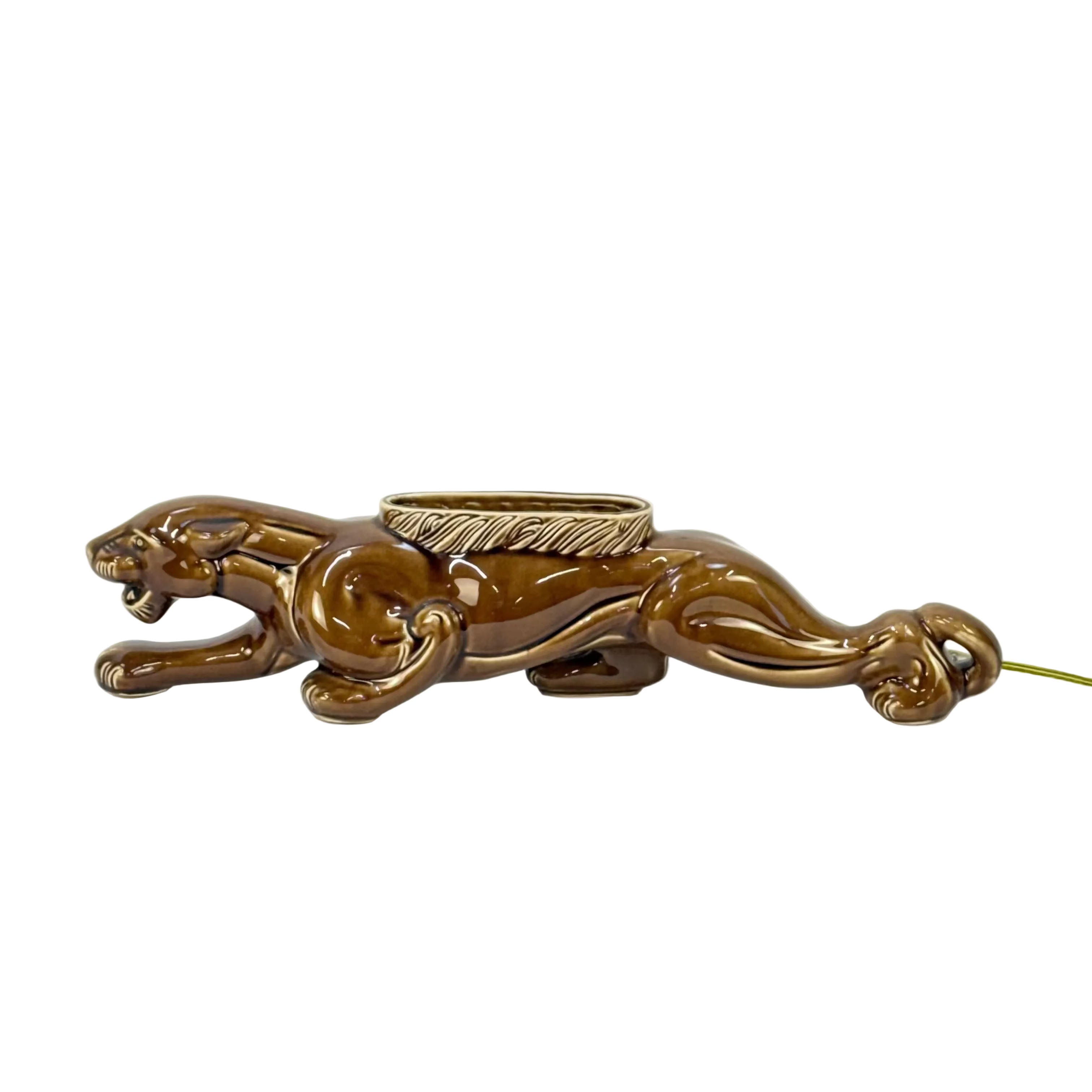 Bronze panther-shaped object with a ring on a white background