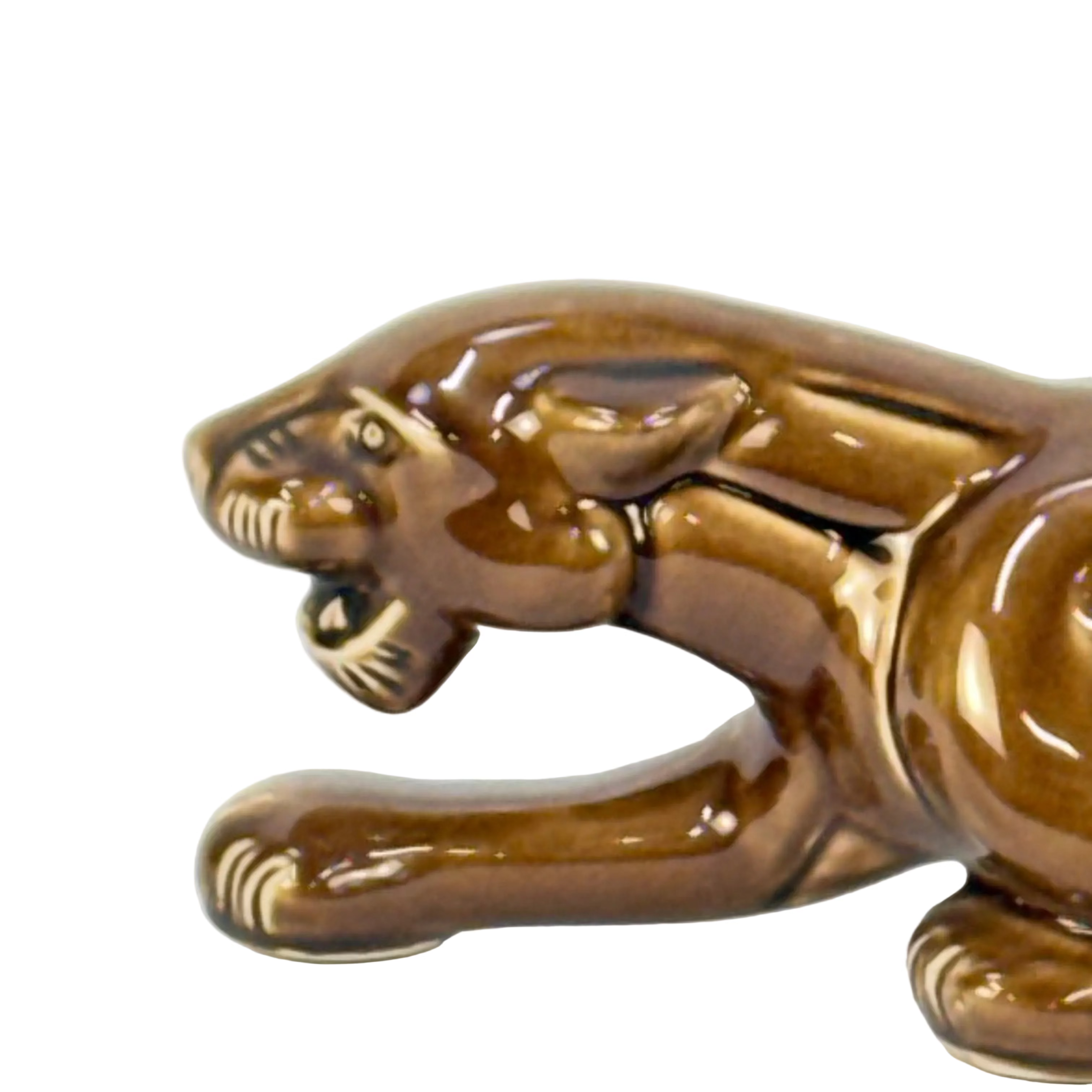 Brown ceramic panther figurine on a white background
