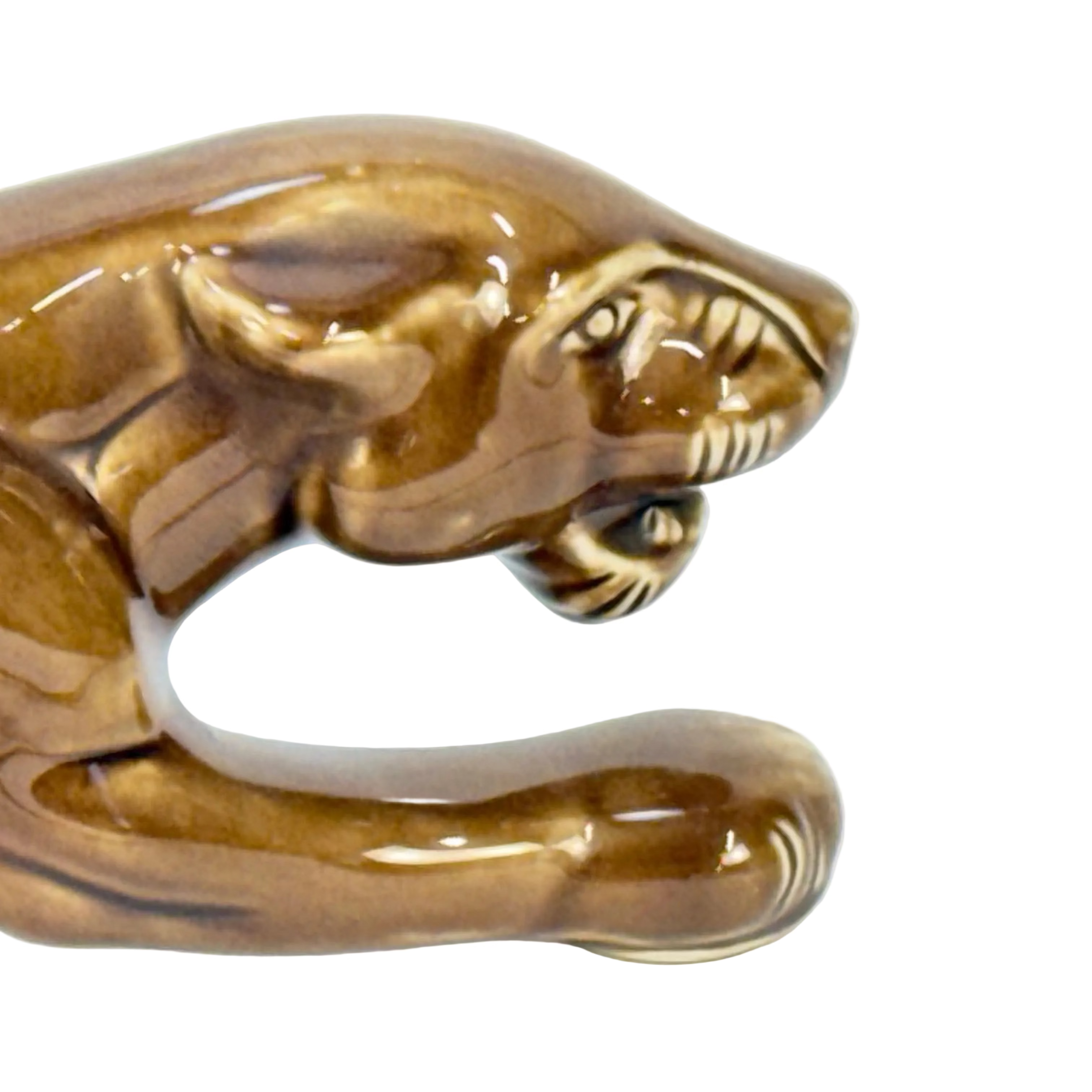 Brown ceramic tiger figurine on a white background