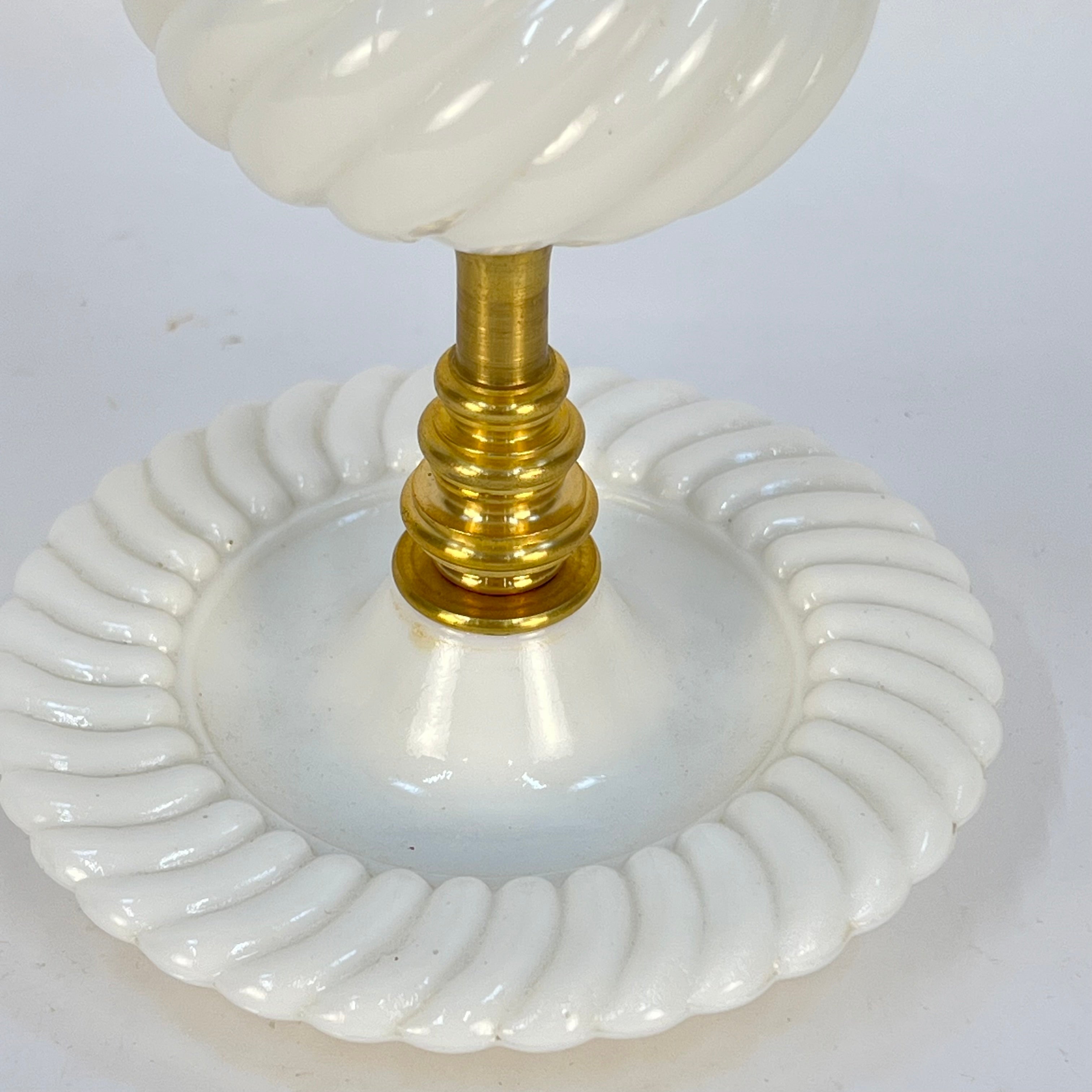 White ribbed lampshade with gold fixture on a white background