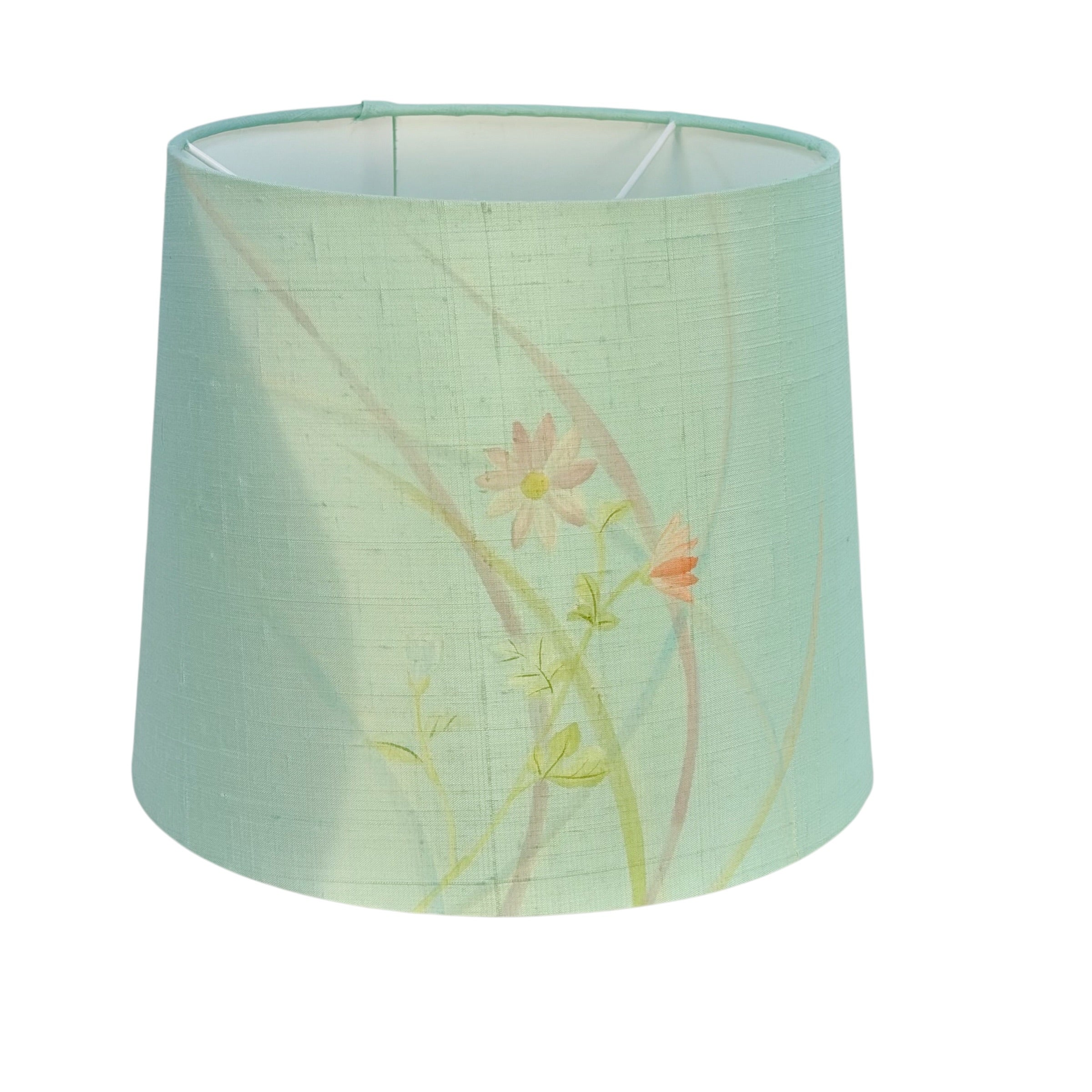 A tapered fabric lampshade in a pale mint green color, decorated with a delicate floral print of pink and orange flowers with green stems.