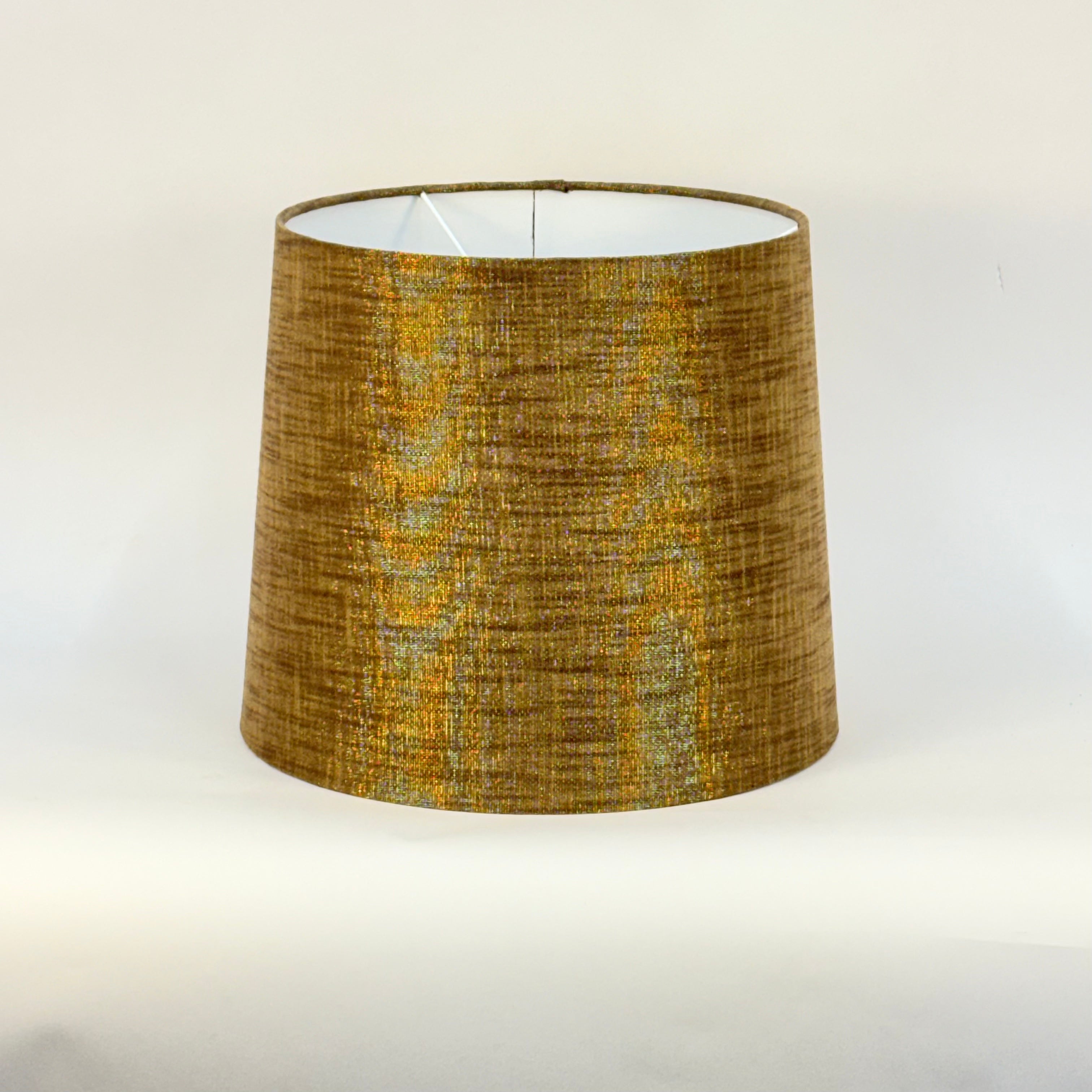 Textured brown metallic lamp shade on a white background