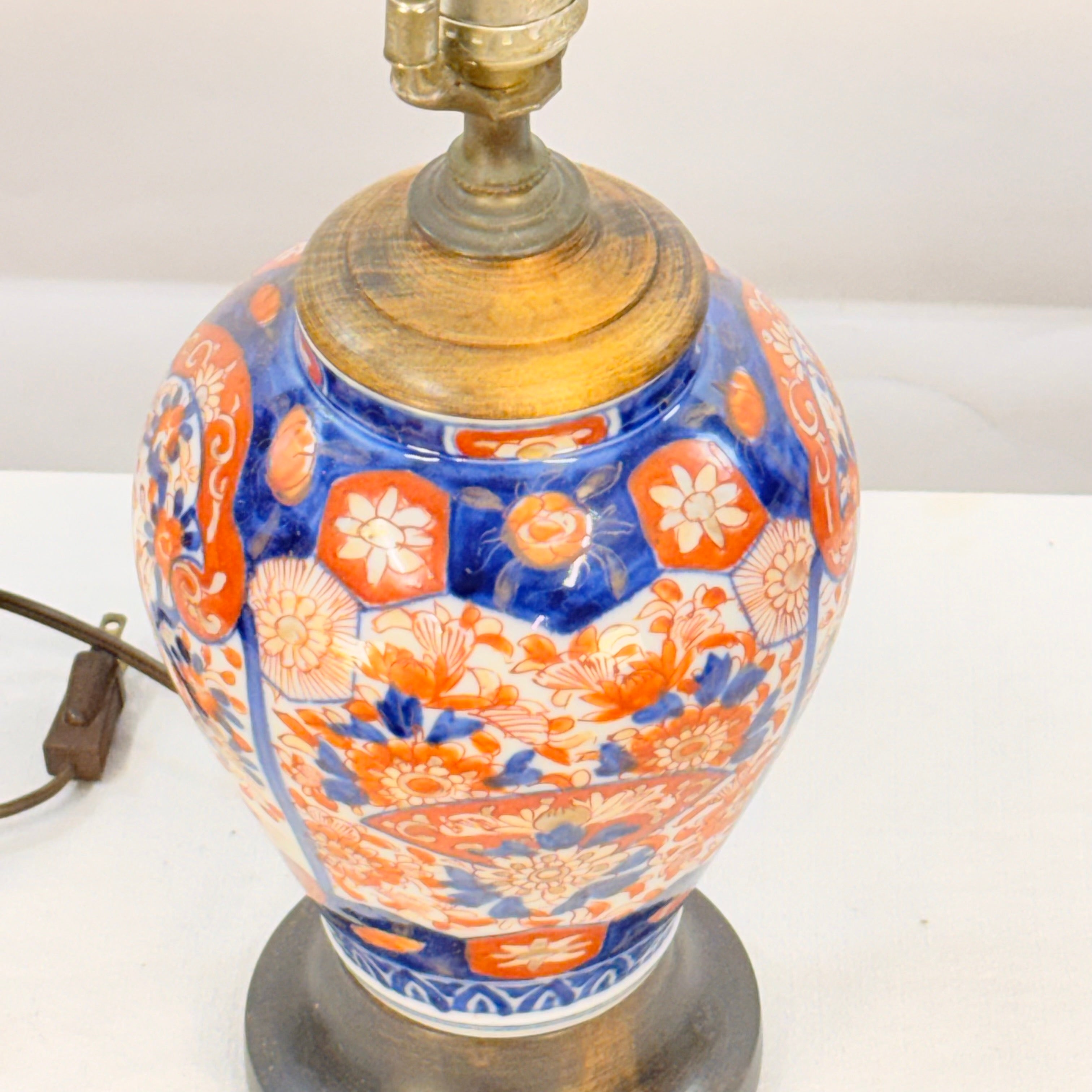 Decorative lamp with blue and orange floral patterns on a white background