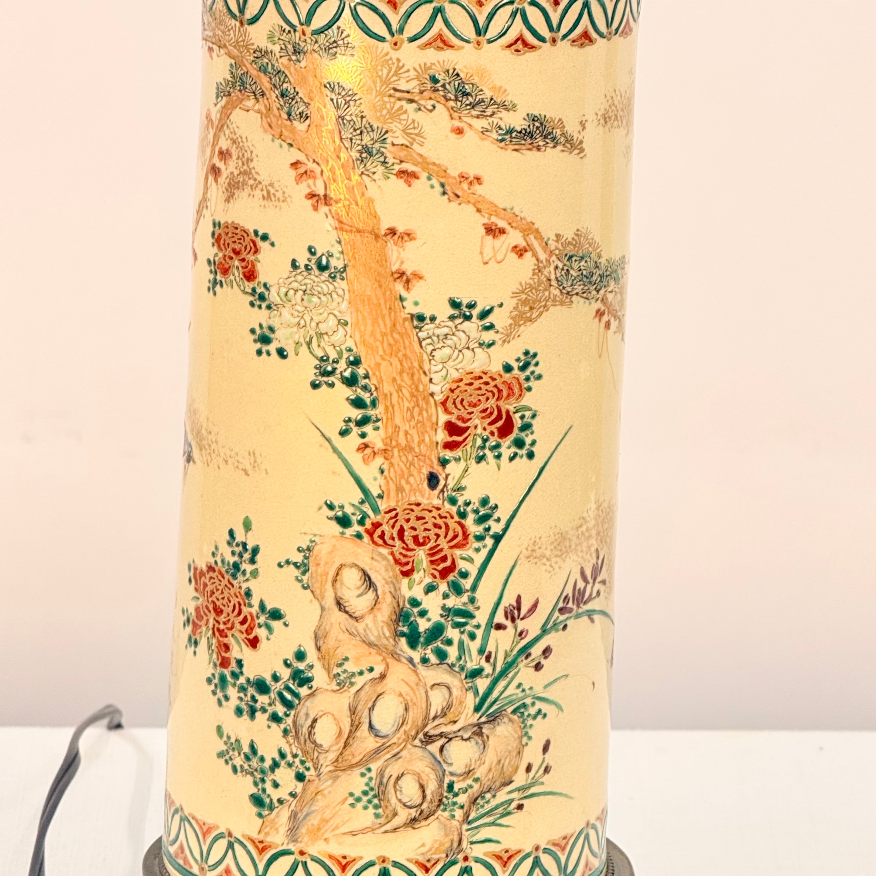 Decorative lamp with floral and tree design on a beige background