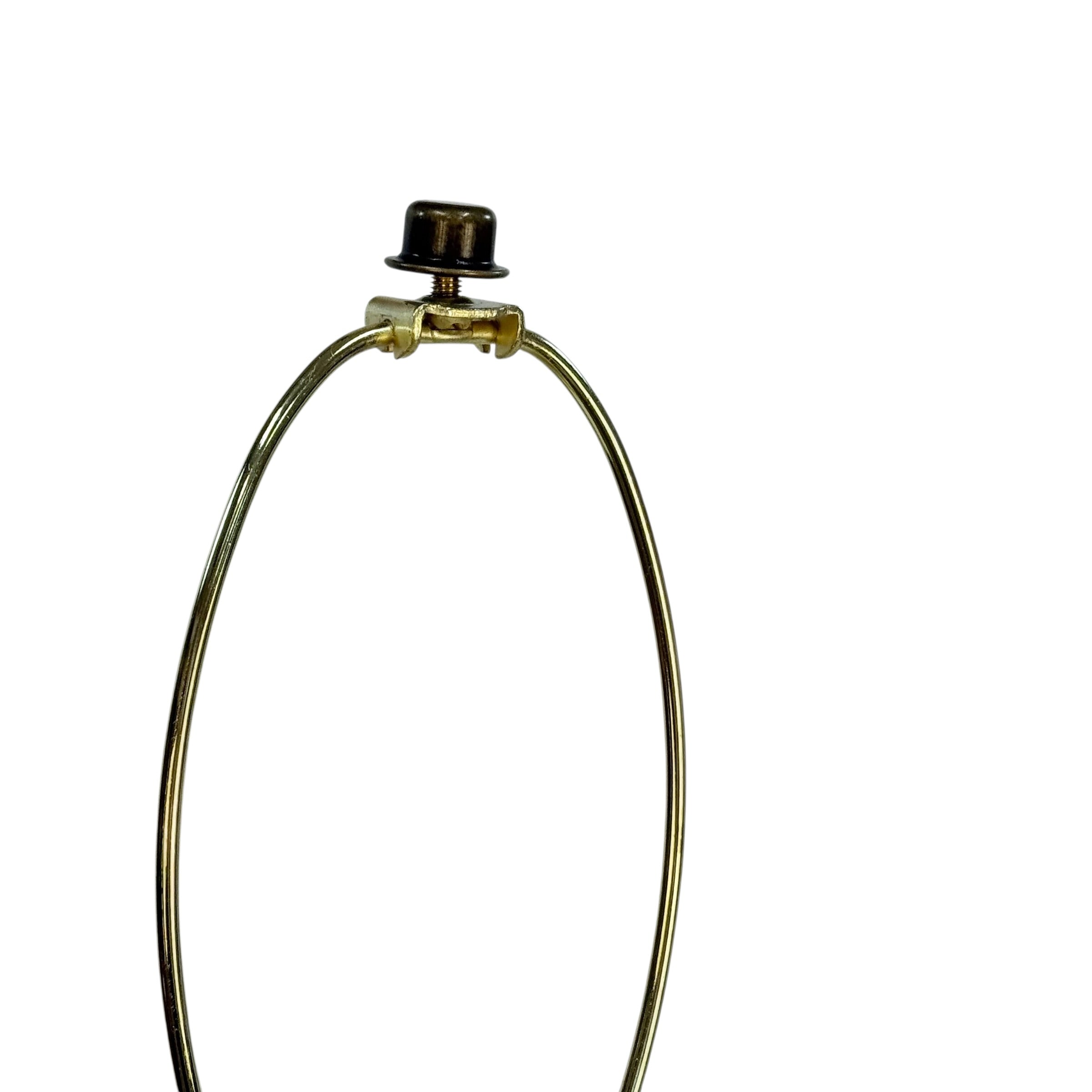 A close-up of a brass lamp shade stem with a small black top finial, shown against a solid white background.