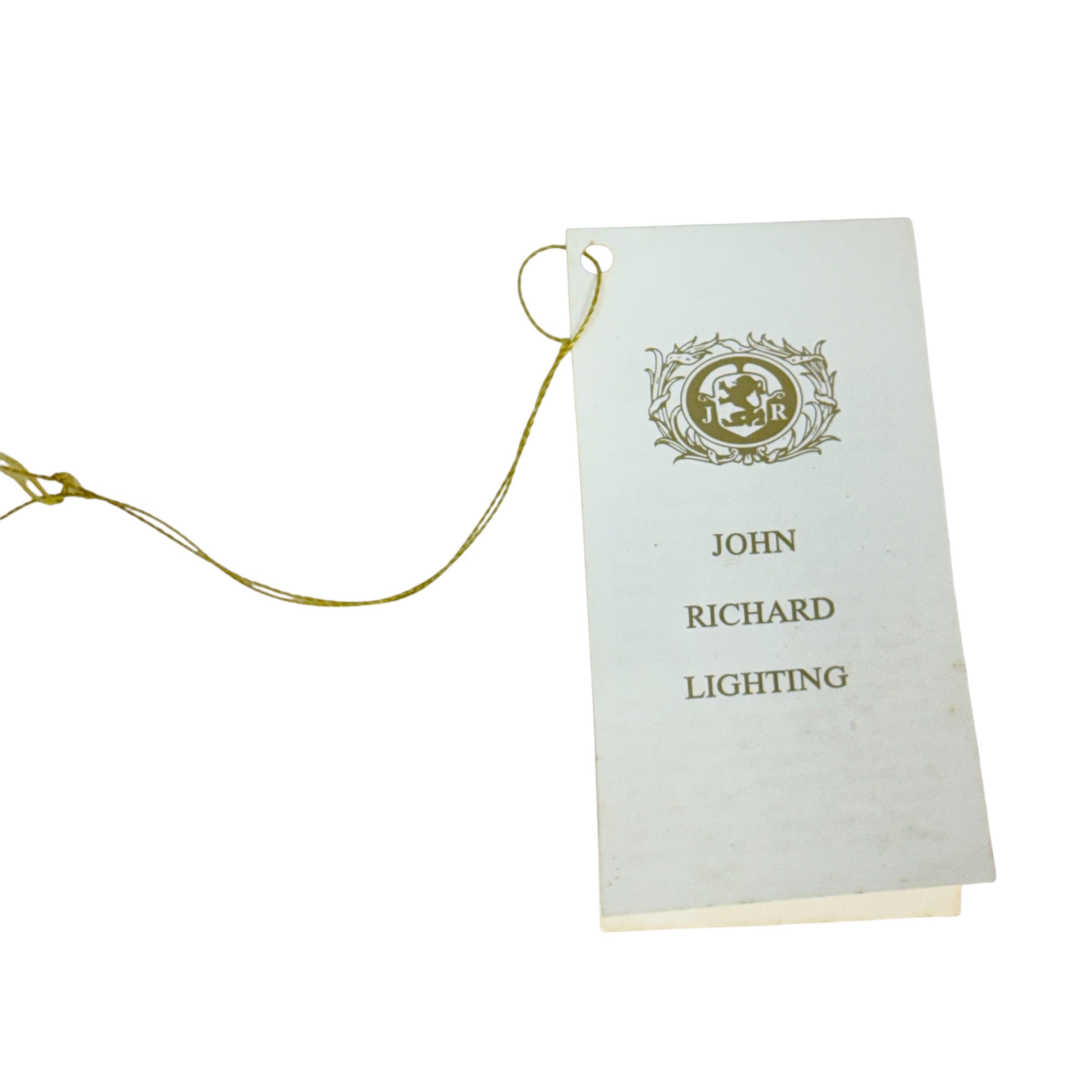 A vintage white paper hangtag with a gold foil crest and the text 'JOHN RICHARD LIGHTING', attached to a gold string, shown on a plain white background.