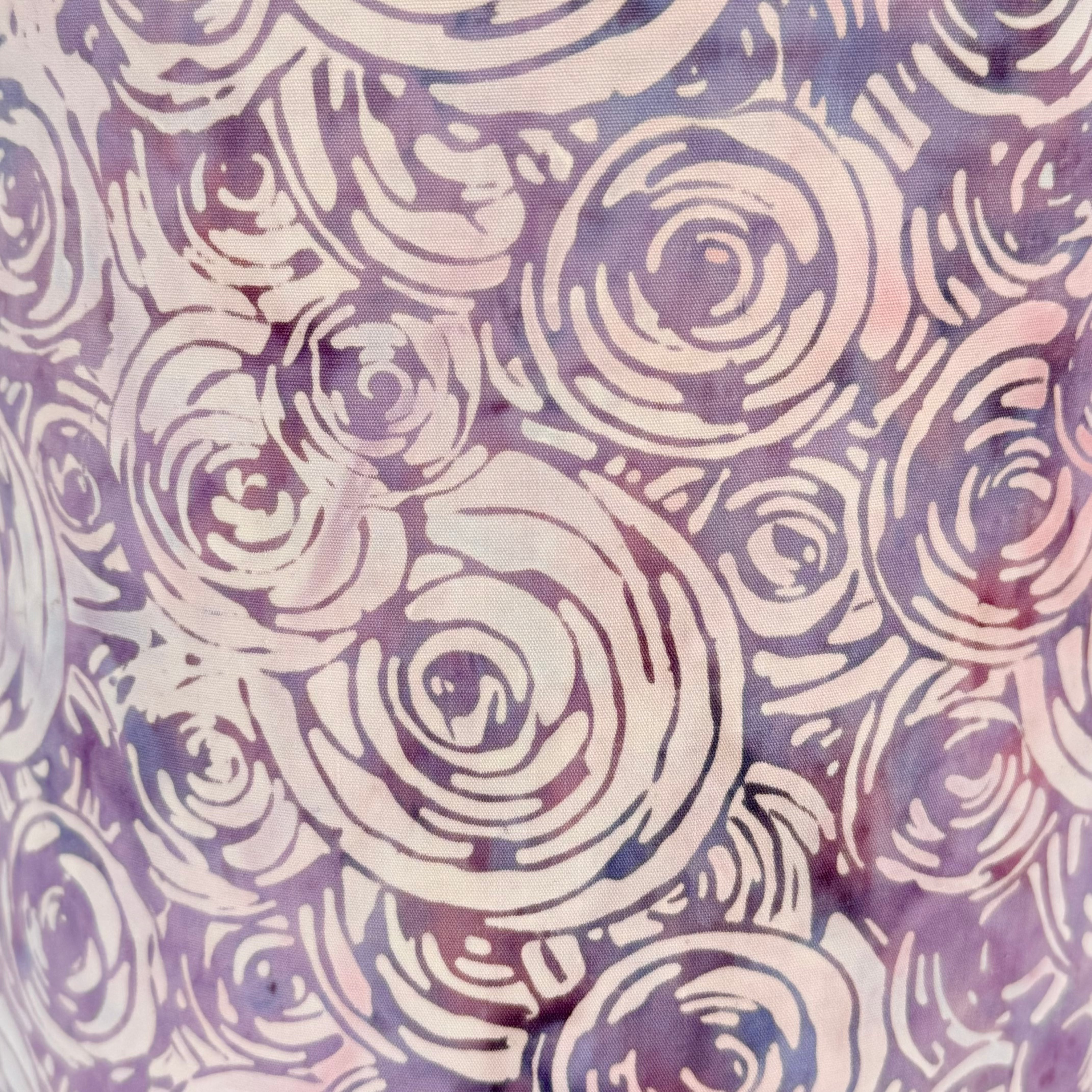 Pattern of concentric circles in soft pink and purple on a matching background