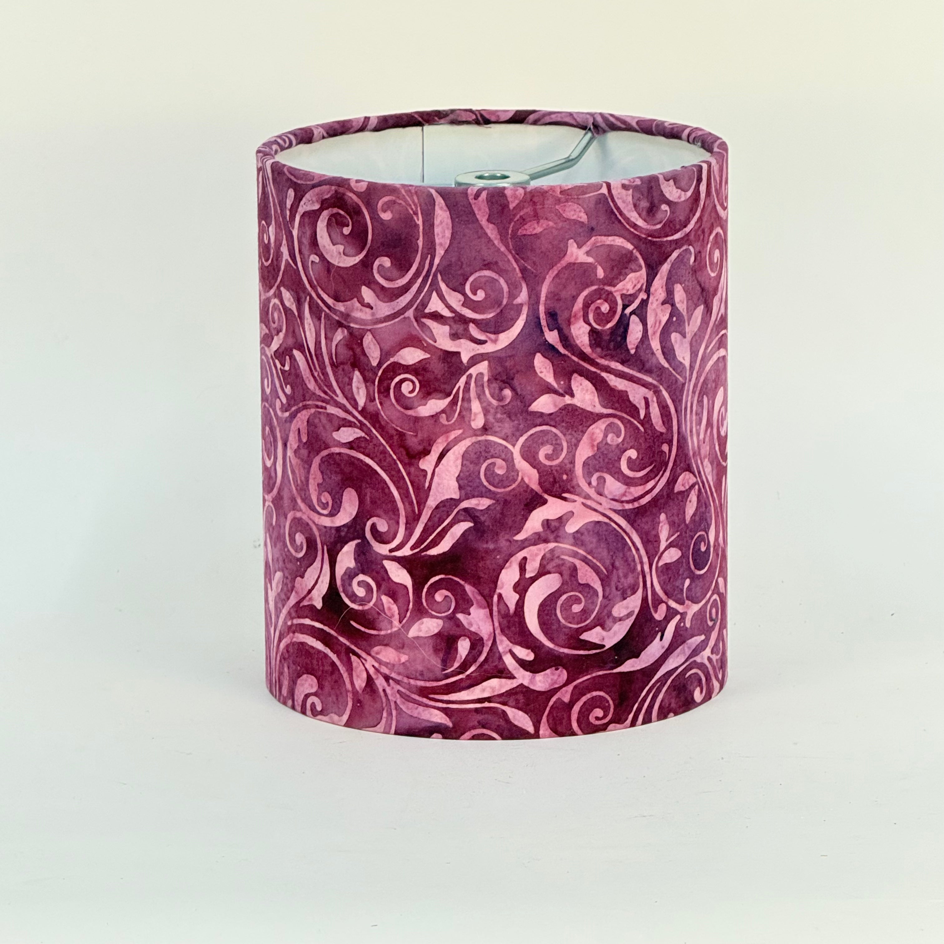 Decorative lampshade with a purple floral pattern on a white background
