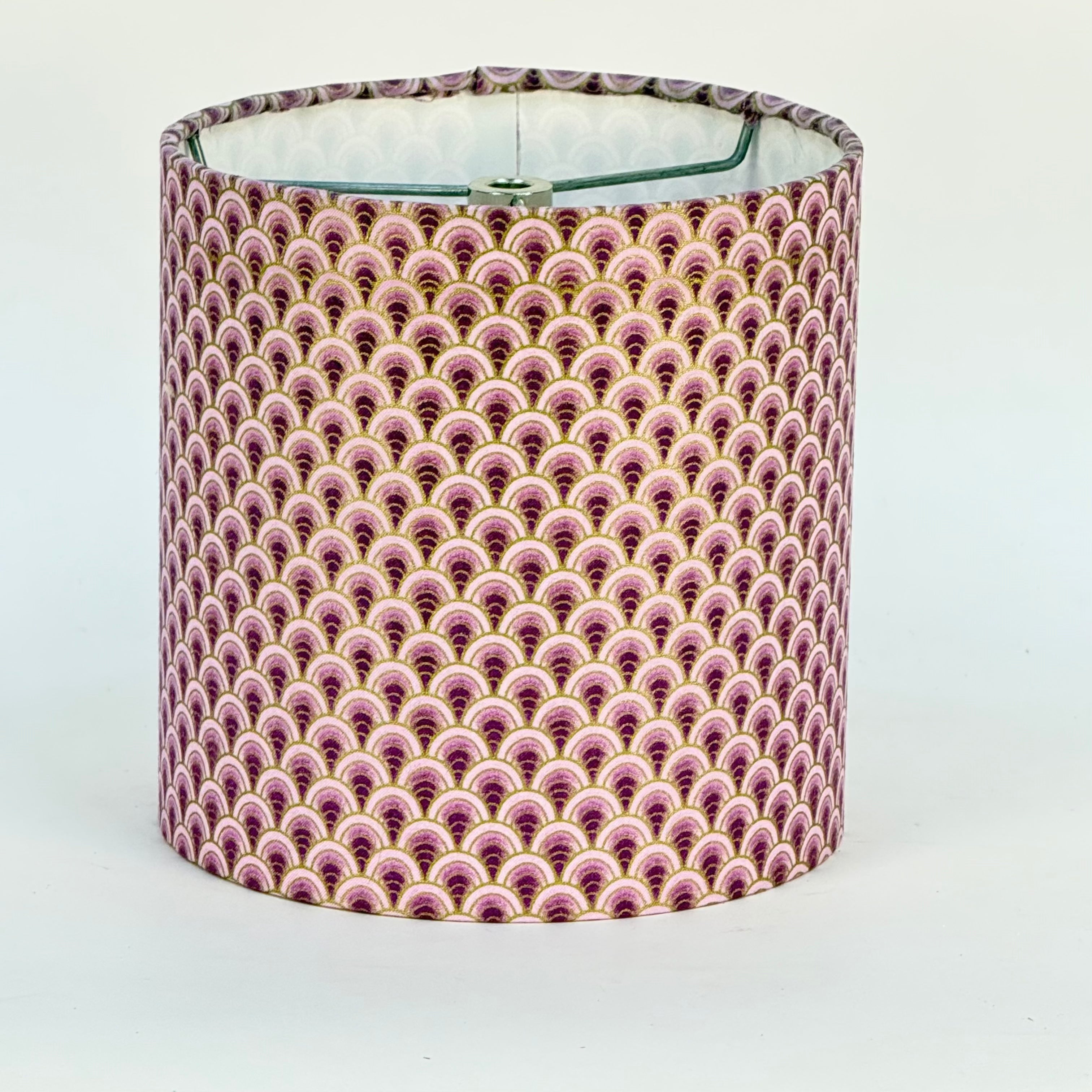 Lampshade with a pink and gold pattern on a white background