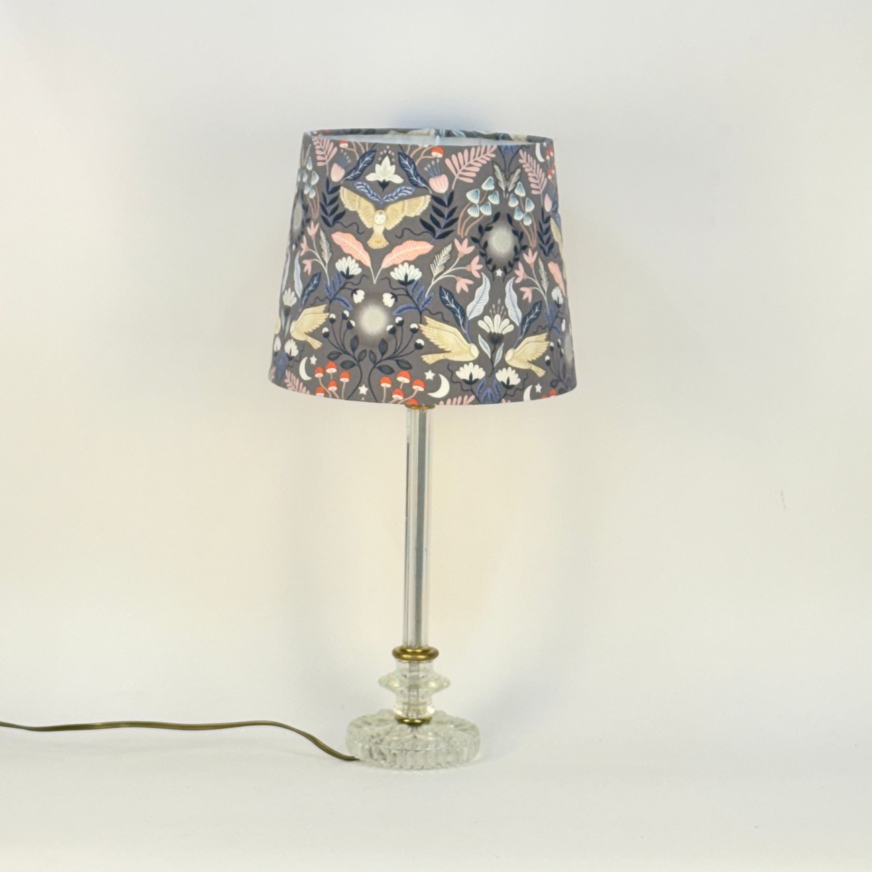 Table lamp with a floral-patterned shade on a white background