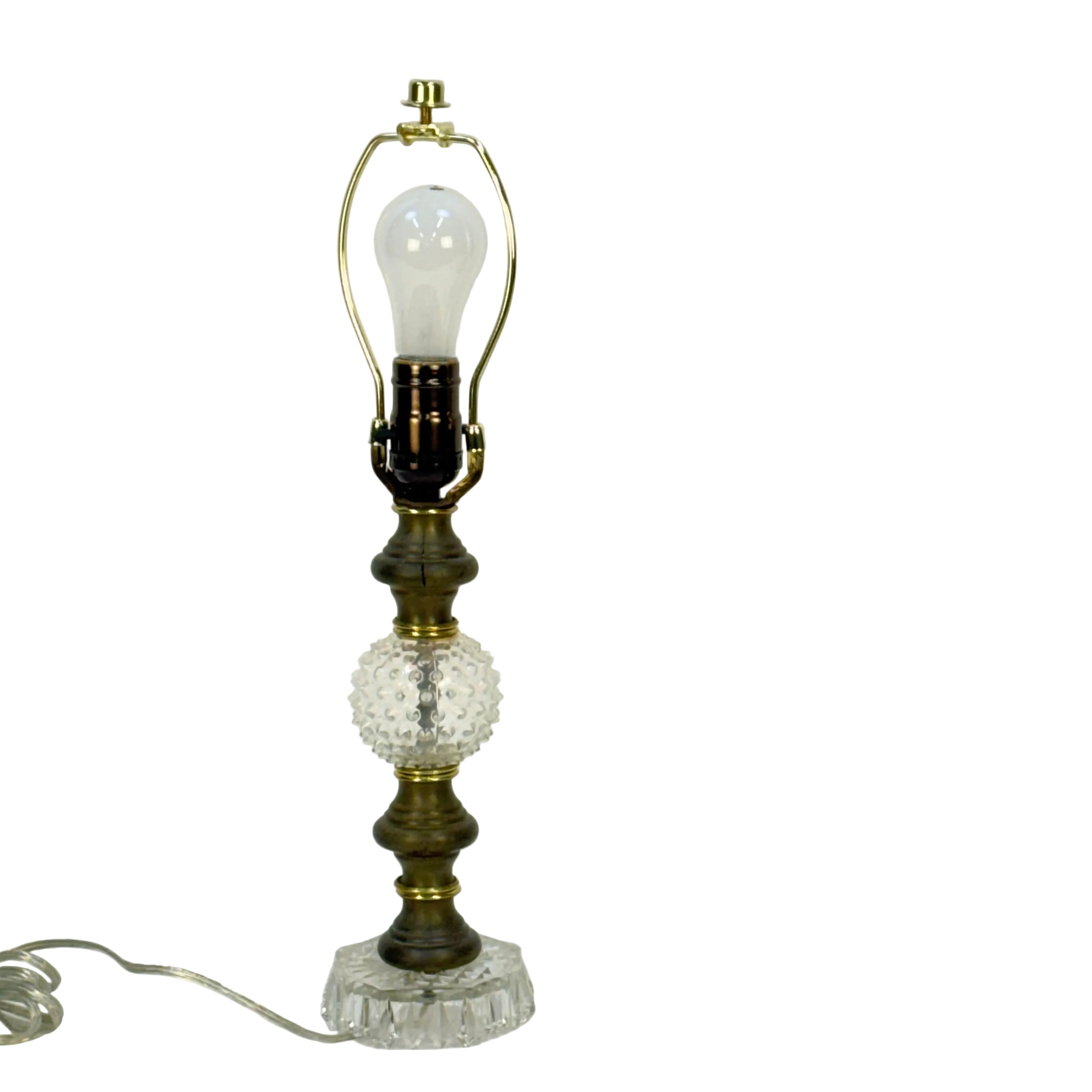 Vintage-style table lamp with decorative base on a white background