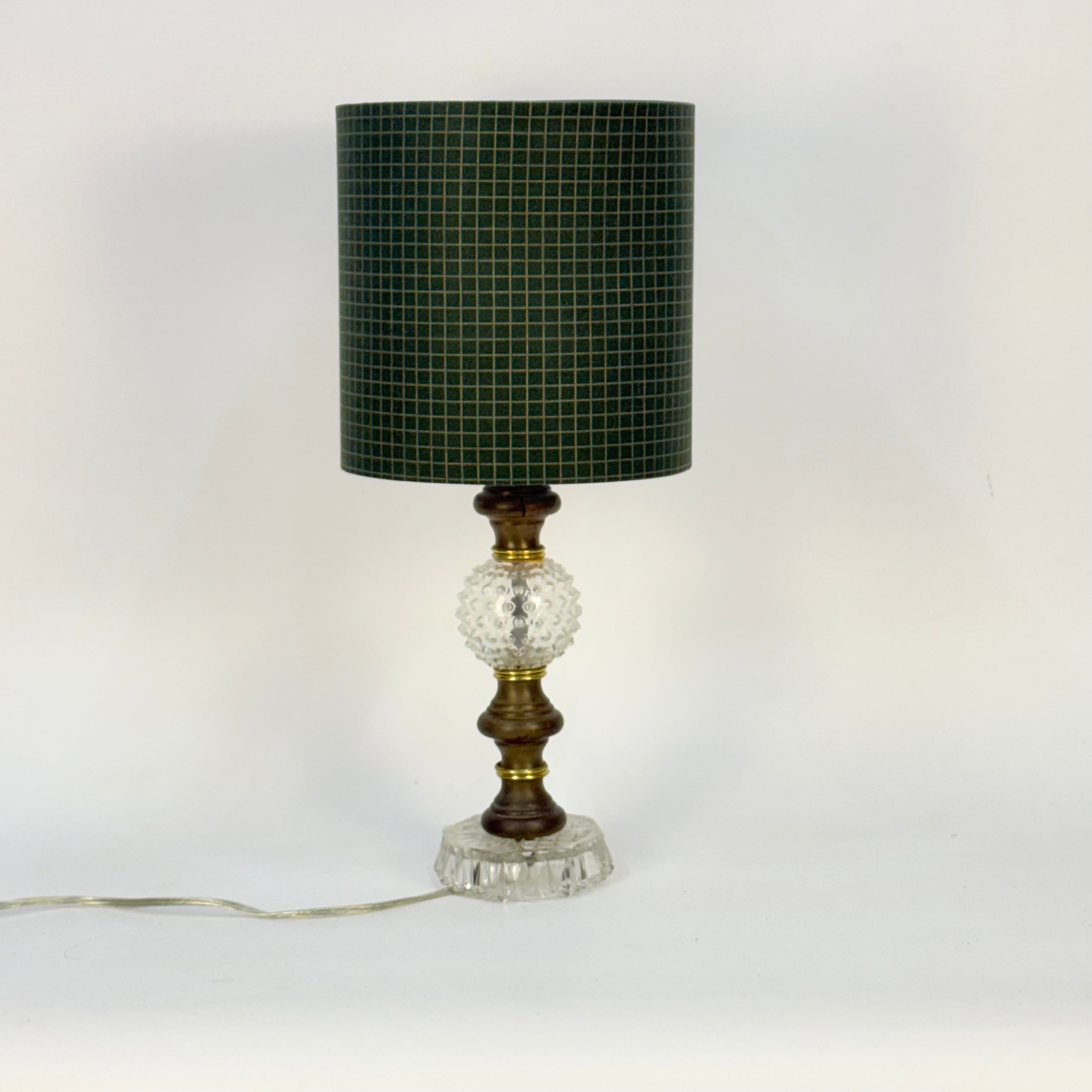 Table lamp with a green mosaic shade on a white background