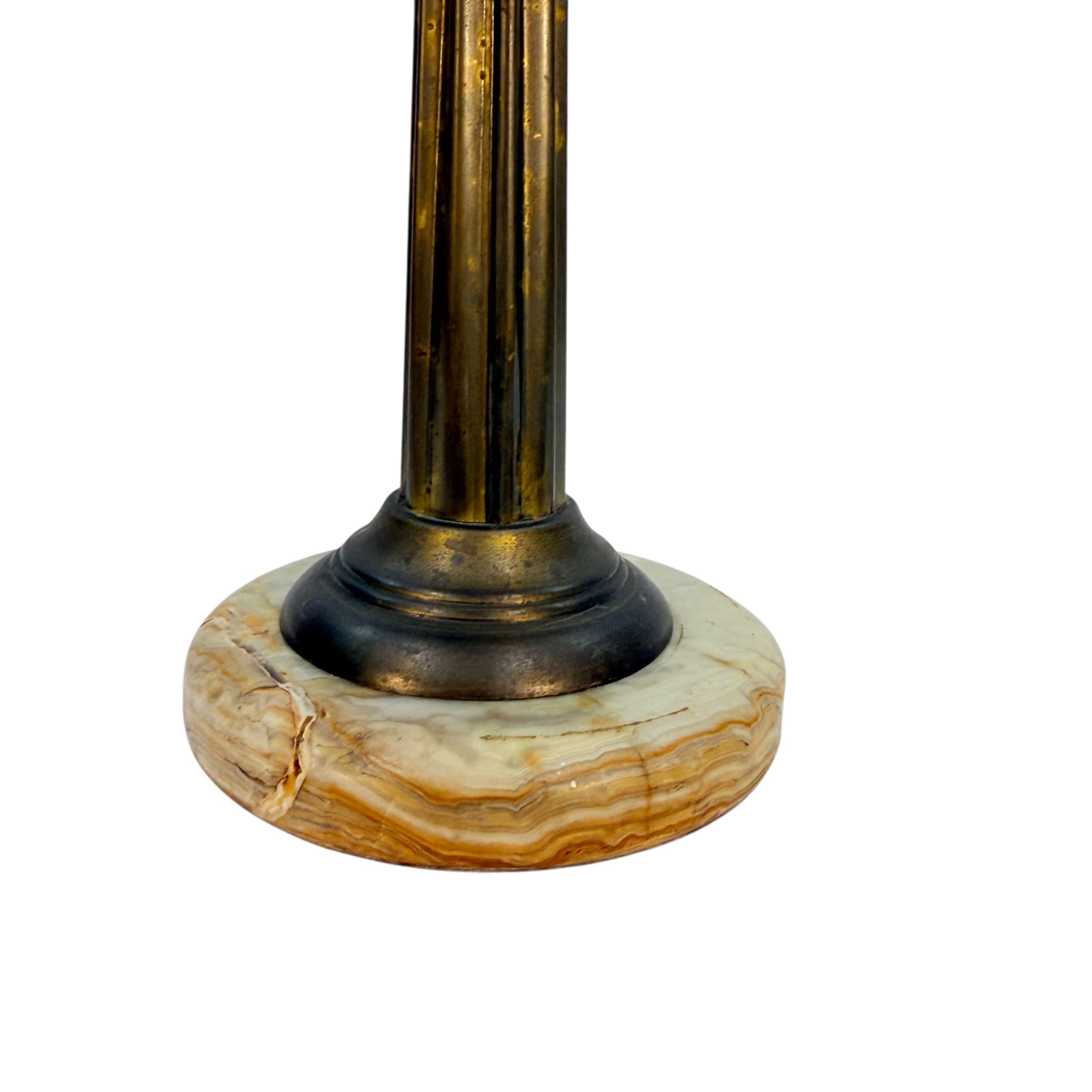 Close-up of a decorative column base with a fluted metallic column and a round natural stone pedestal on a white background.