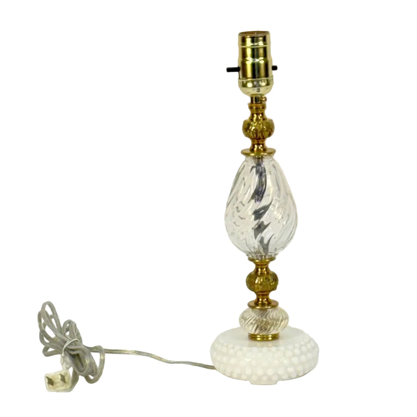 Vintage-style table lamp with glass and brass design on a white background