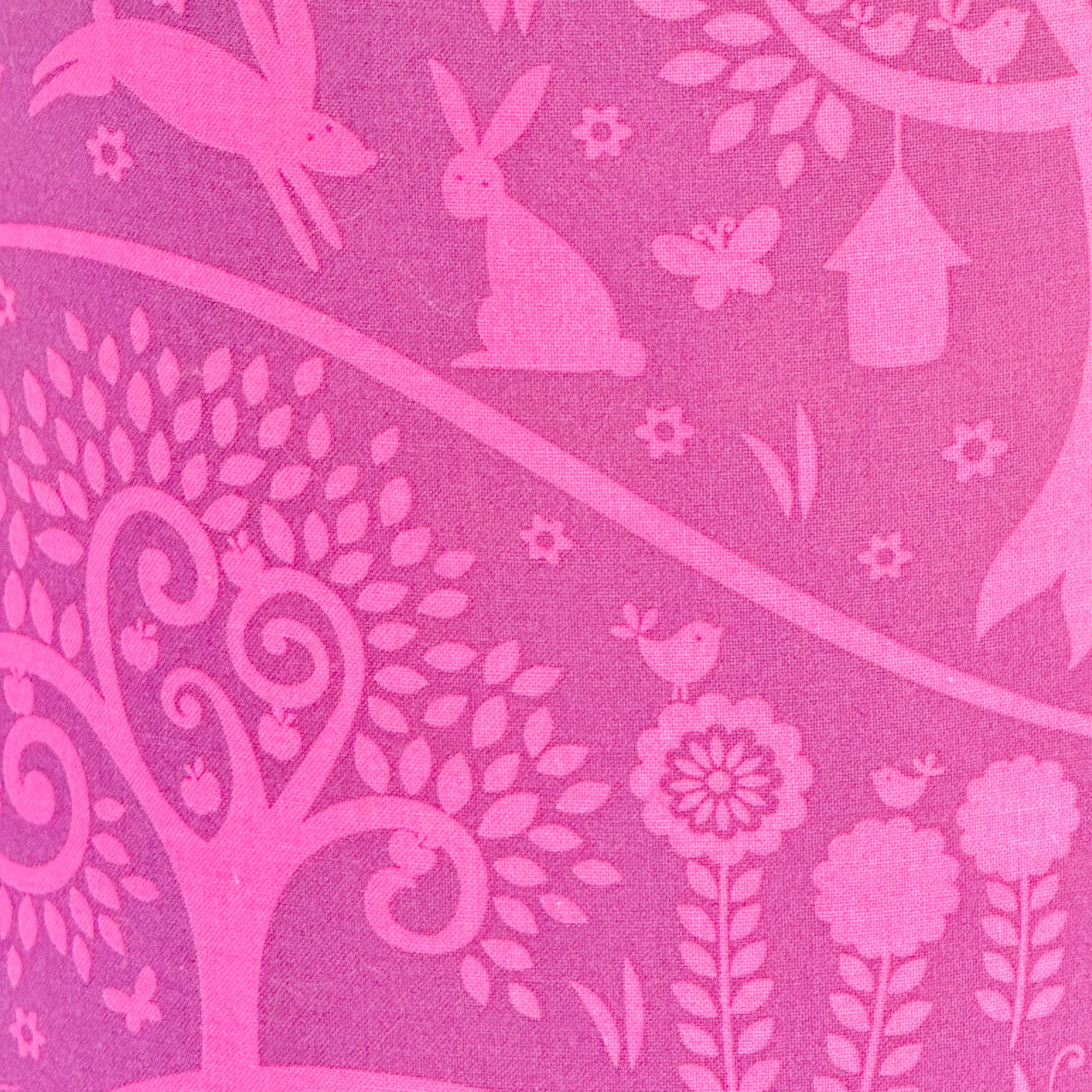 Pink floral, bird, and rabbit pattern on a pink background