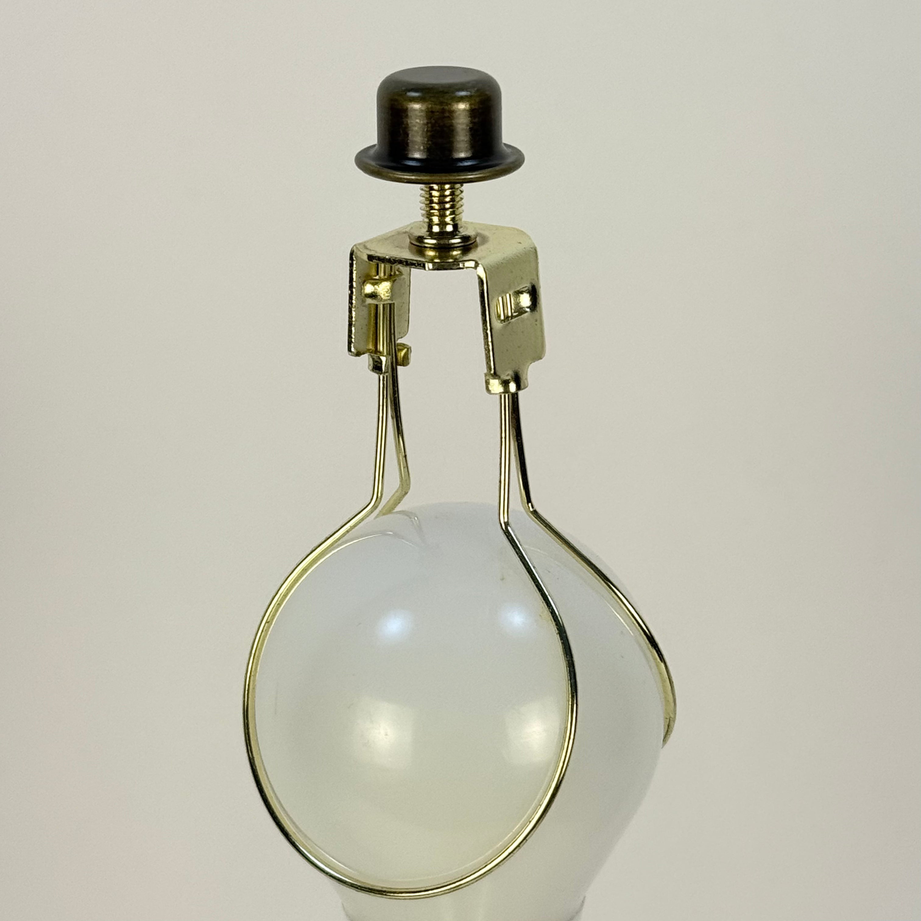 Vintage-style light bulb with brass holder on a beige background