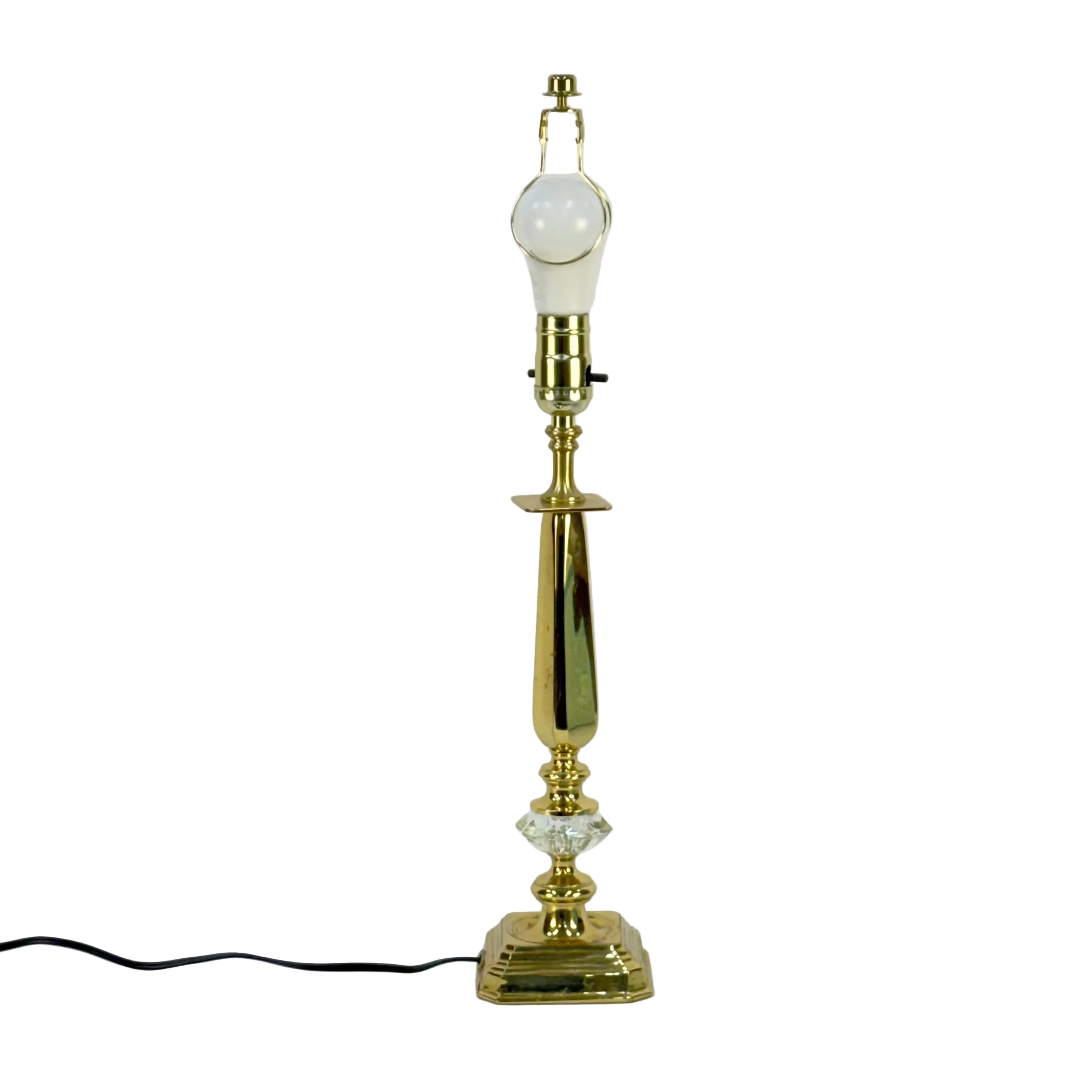 Gold table lamp with a white bulb on a white background