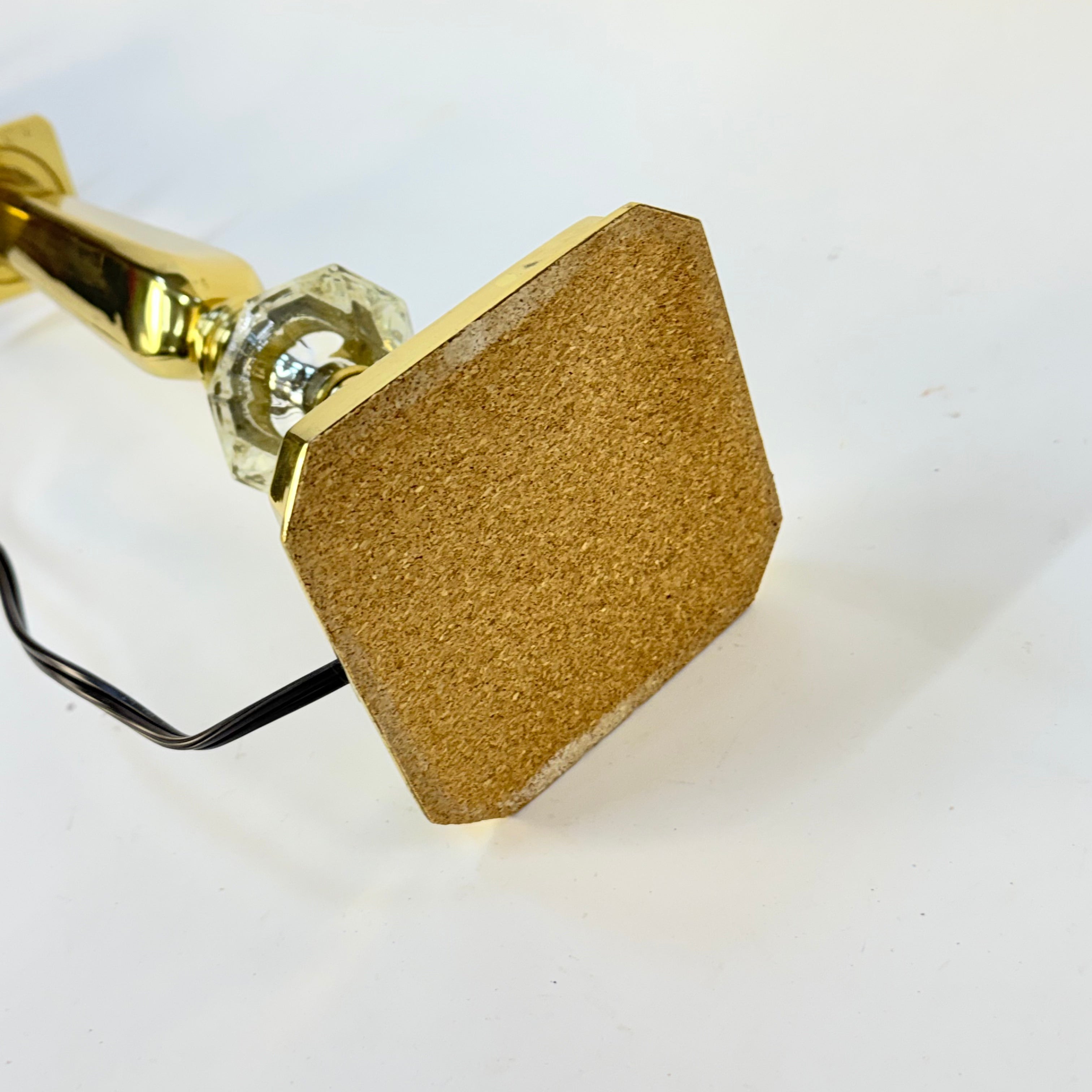 Hexagonal gold door handle on a white background