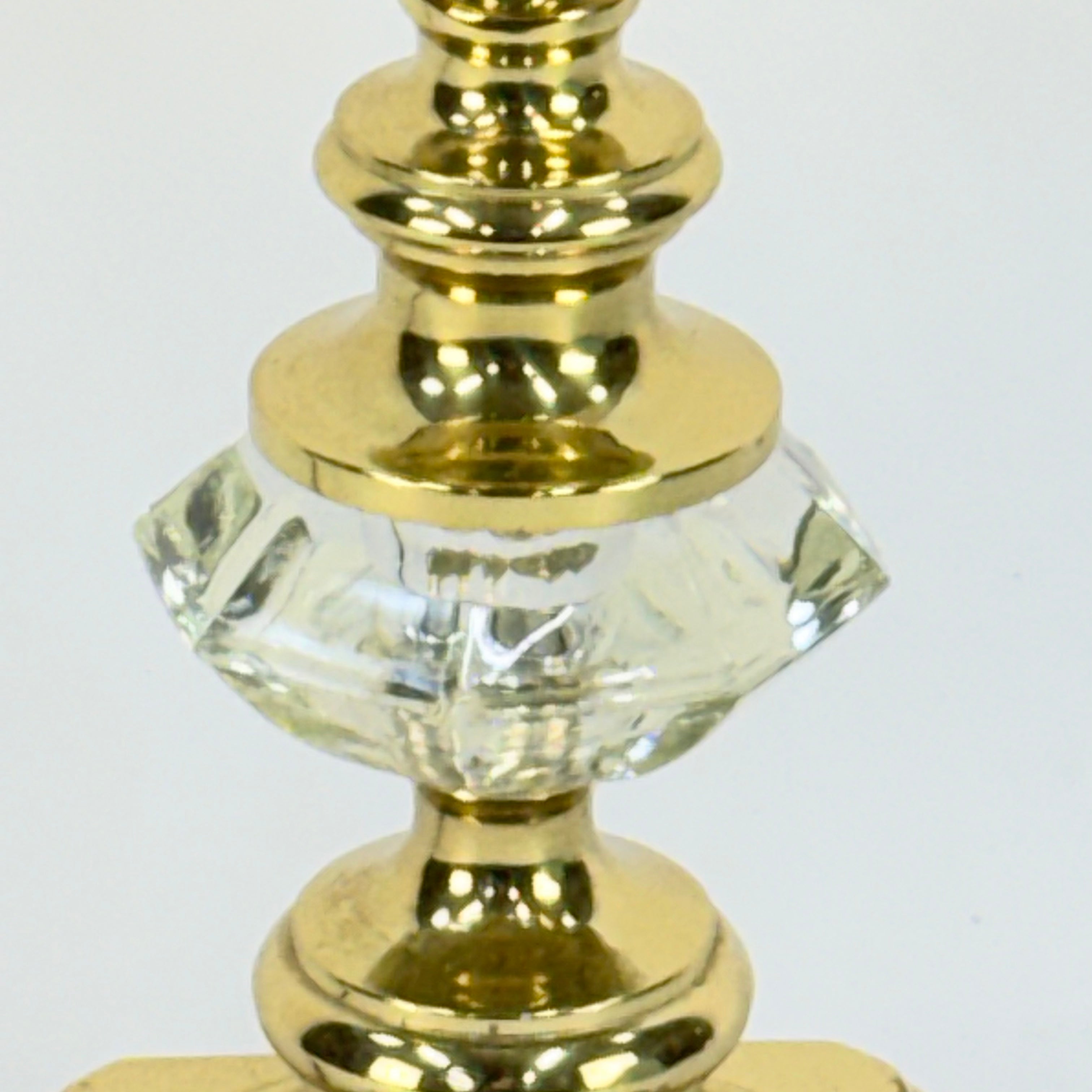Close-up of a gold and crystal decorative finial on a white background