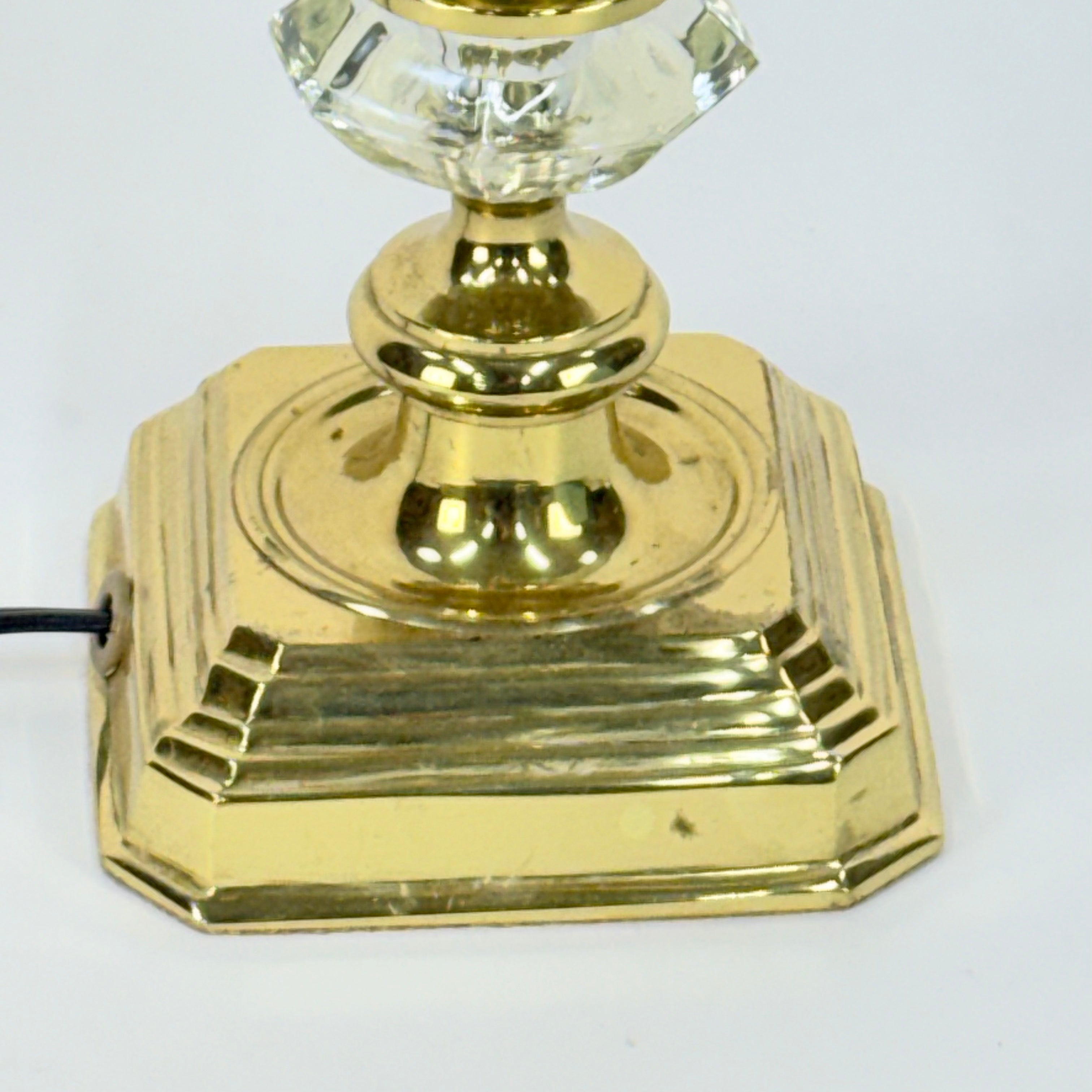 Gold lamp base with crystal top on a white background