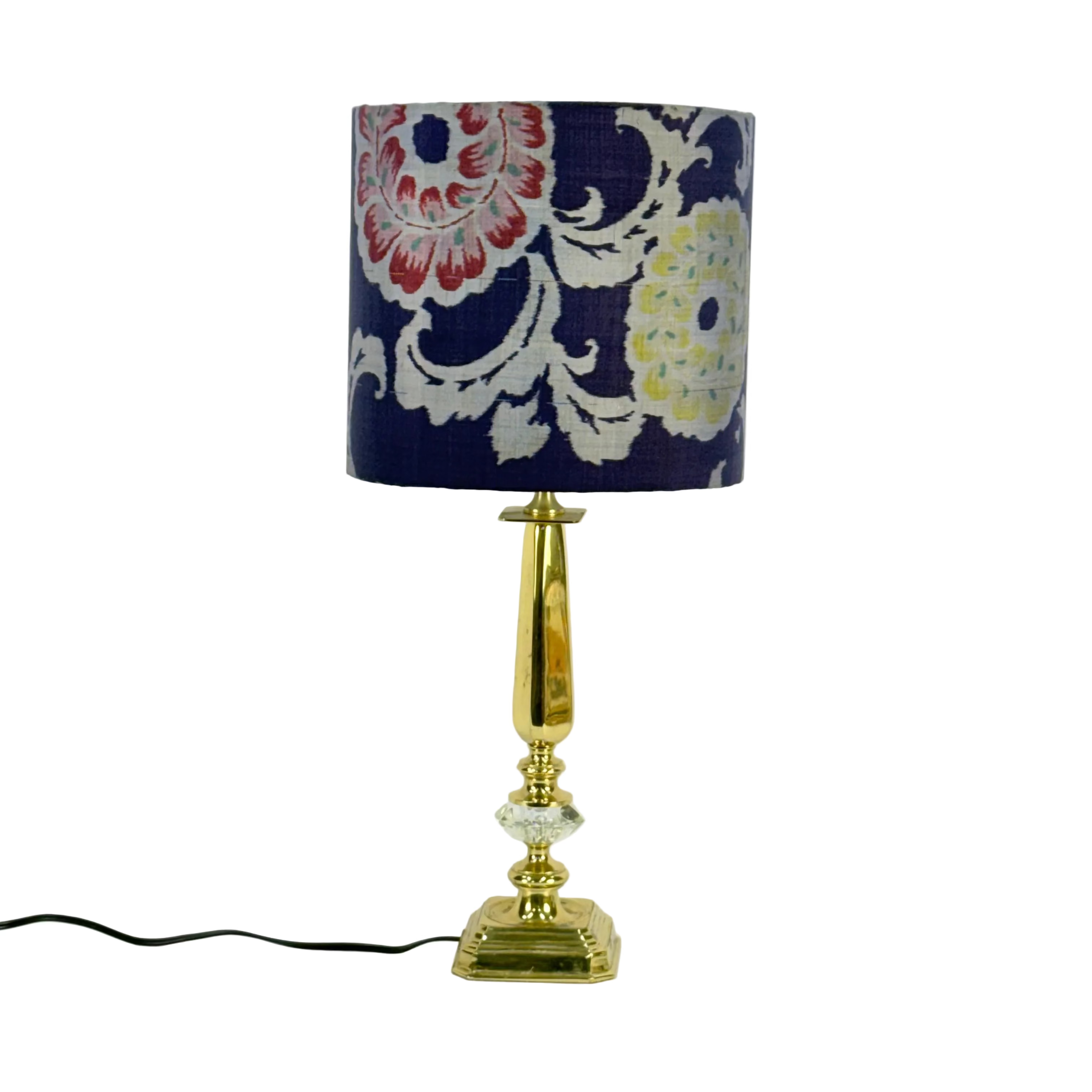 Decorative lamp with a floral-patterned shade on a white background