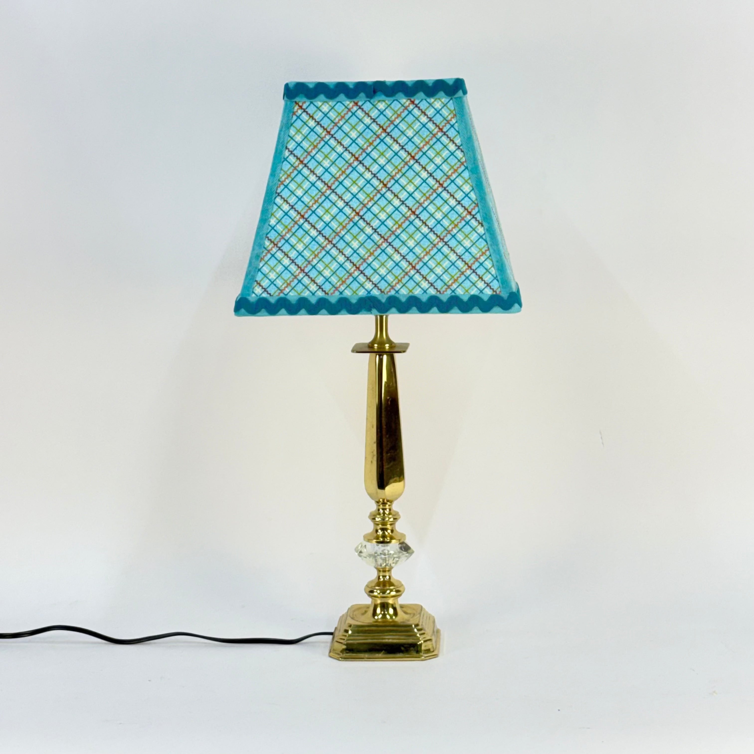 Lamp with a blue checkered shade on a white background