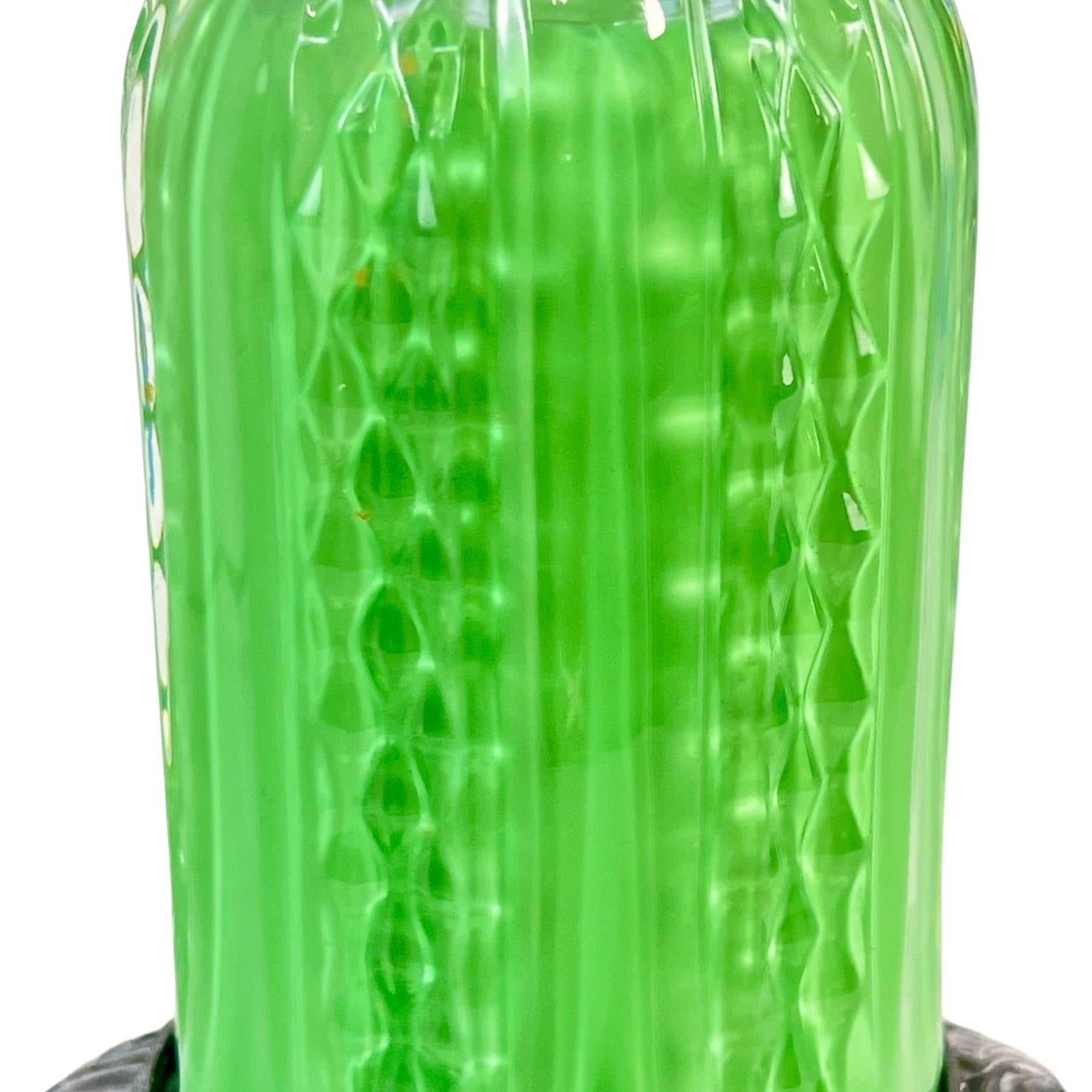 Green glass jar with textured surface on a white background