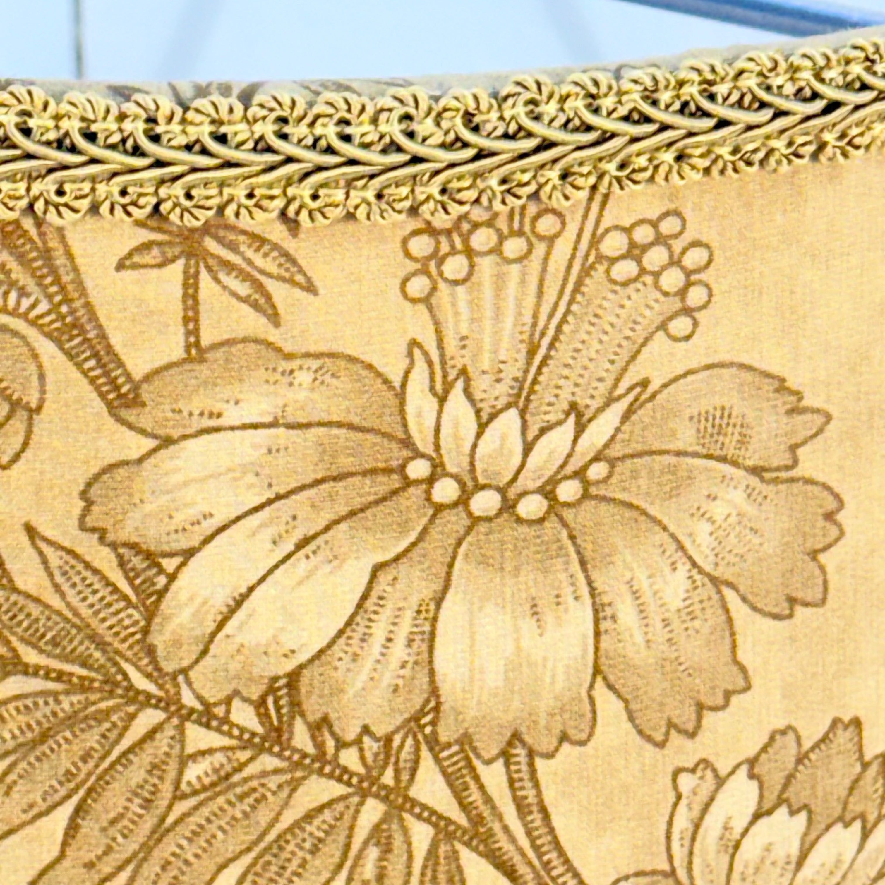 Close-up of a wooden surface with floral carvings and intricate patterns.