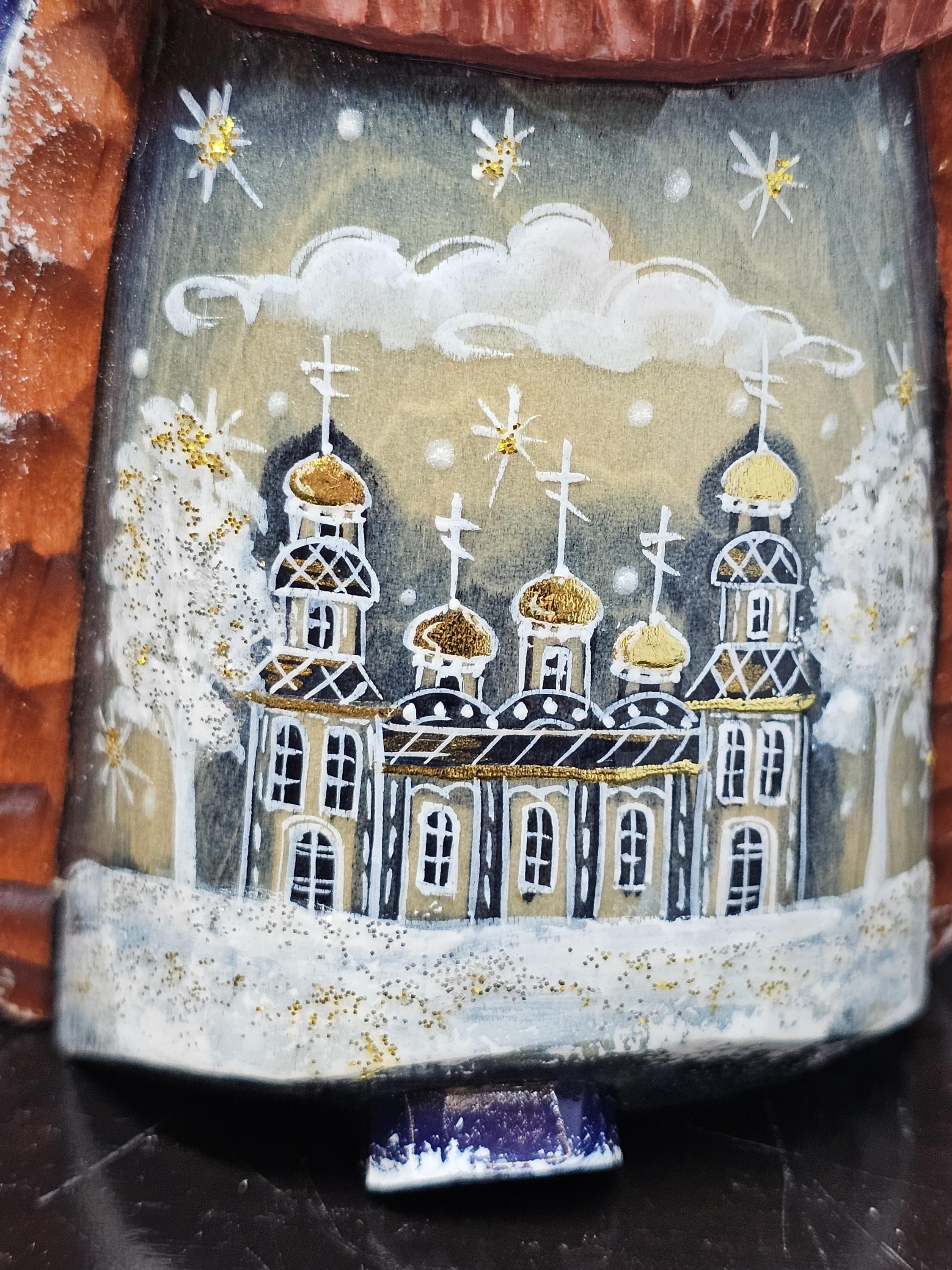 Detail of painting of Russian Orthodox building in blue, gold, white on Ded Moroz' robe
