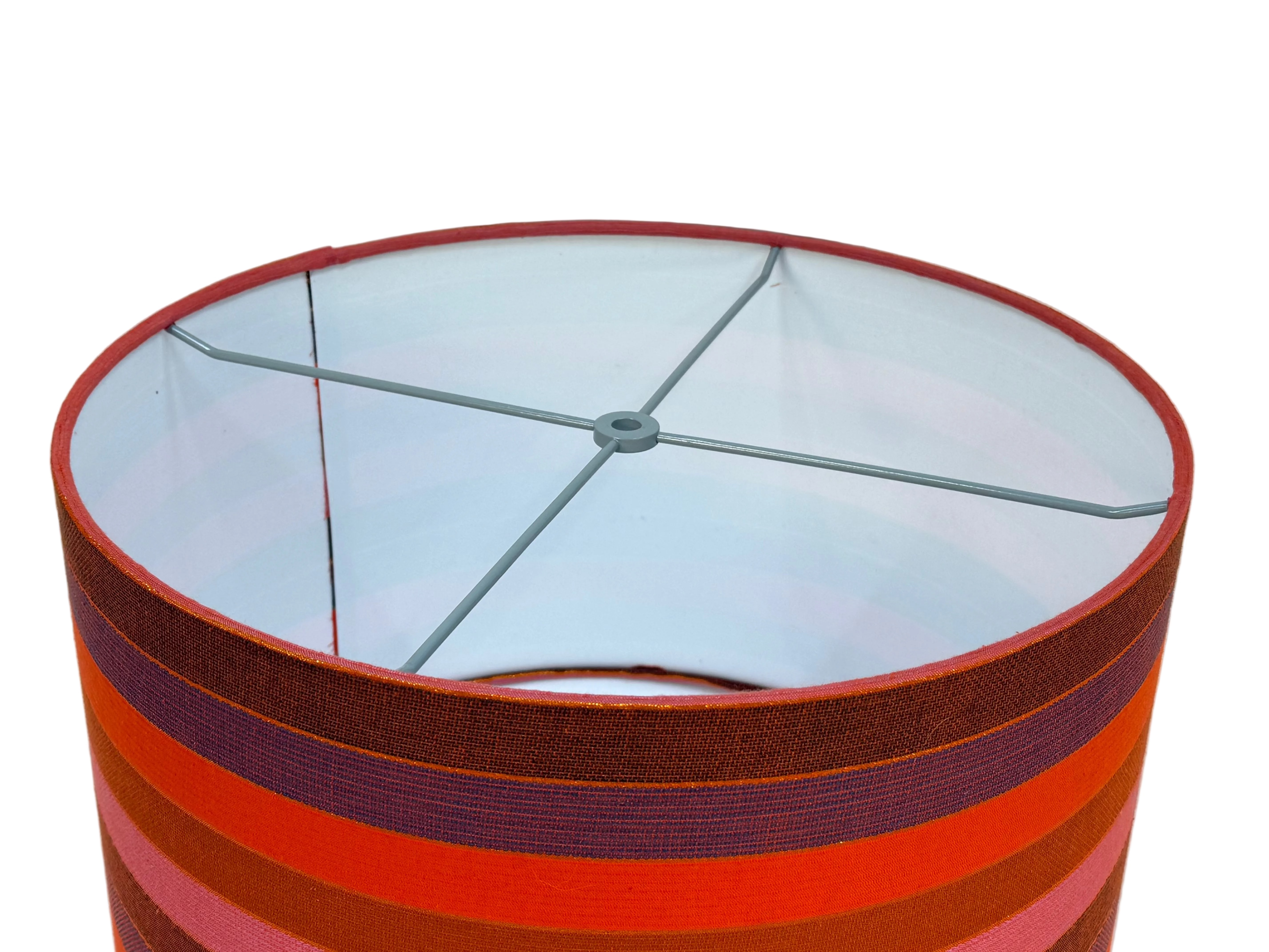 Striped lampshade with red and purple bands on a white background