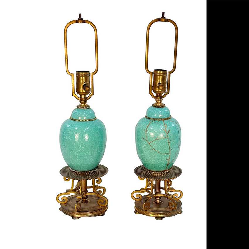 A pair of vintage-style table lamps with glossy turquoise glazed ceramic vases and ornate gold-finished metal bases and lamp shades, shown on a white background with a black vertical bar on the right.