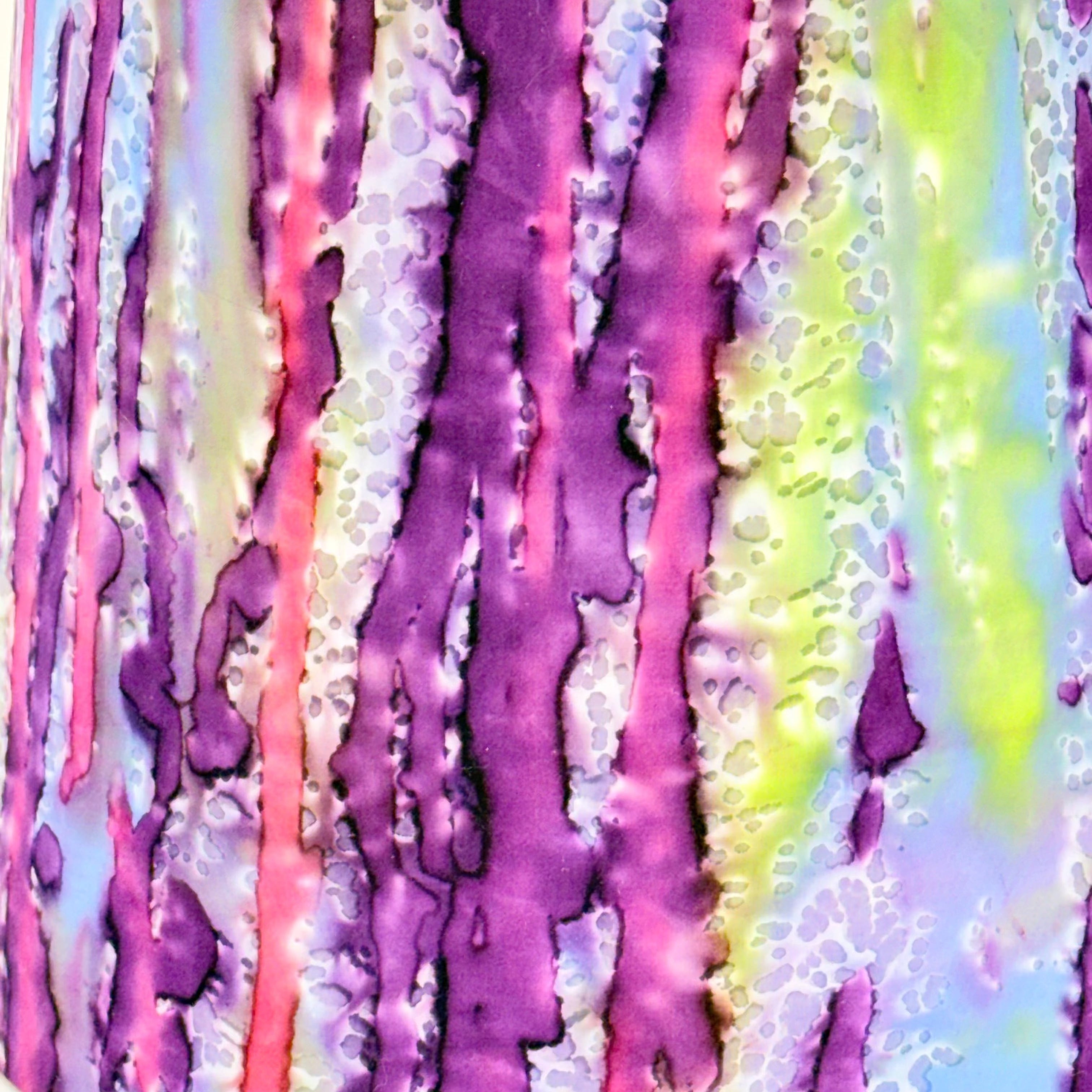 Colorful abstract pattern with purple, pink, and green hues.