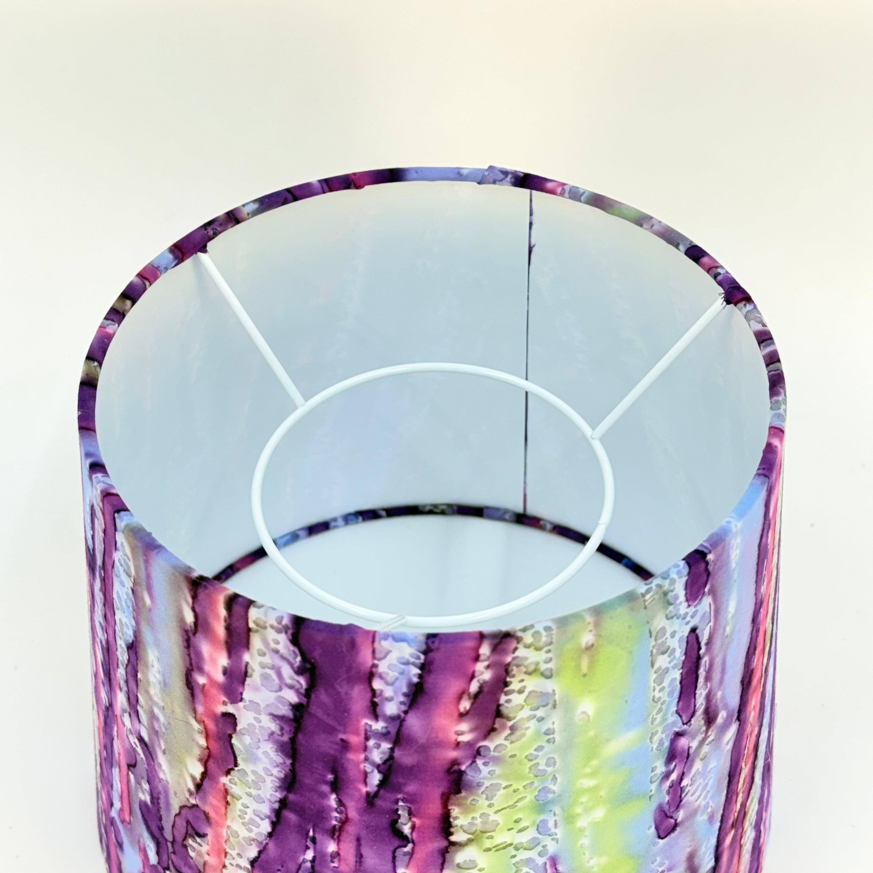 Glass vase with colorful, iridescent pattern on a white background