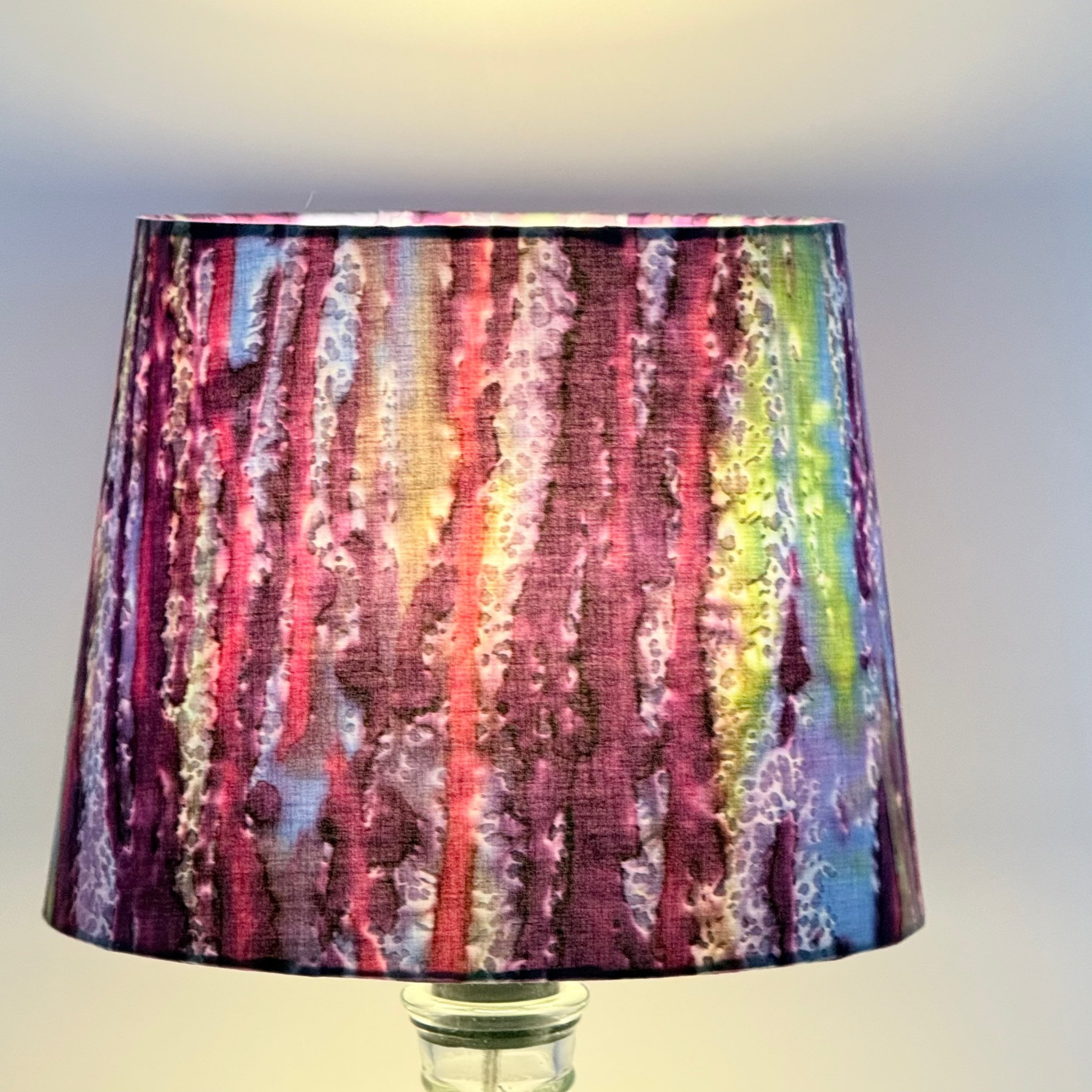 Multicolored lampshade with a pattern on a plain background