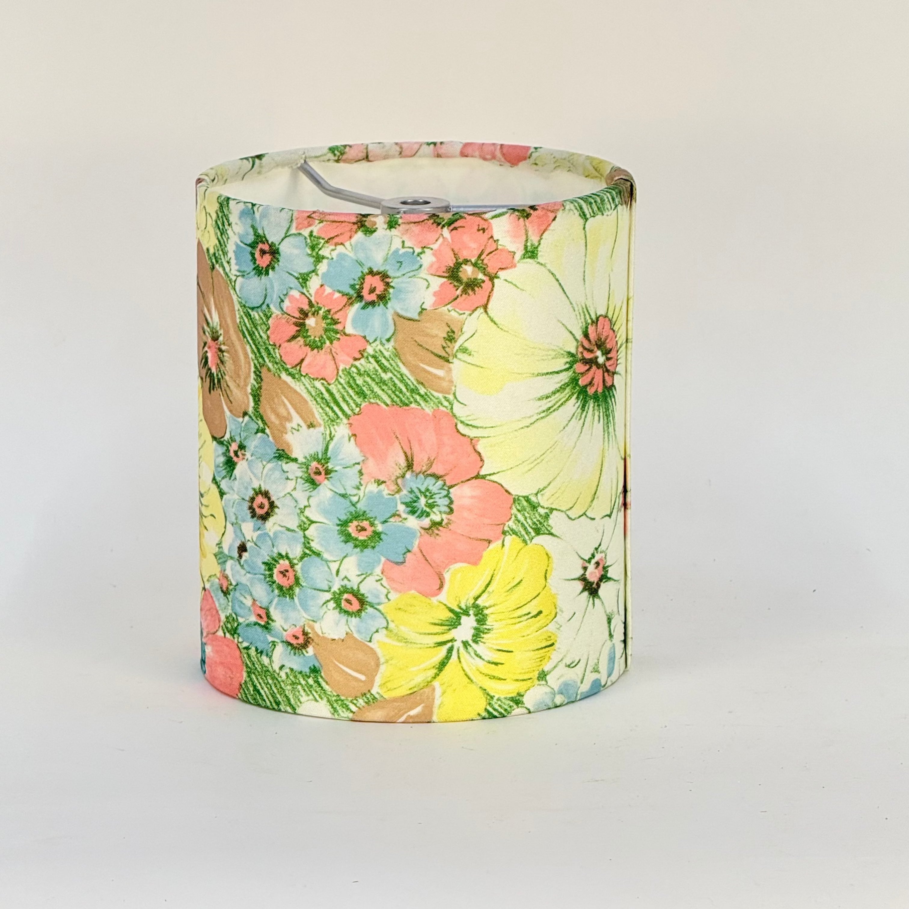 Floral-patterned cylindrical container on a white background