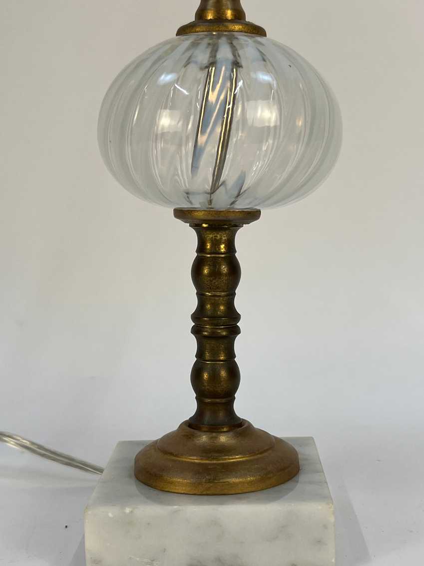 Vintage-style lamp with brass base and marble shade on a white background