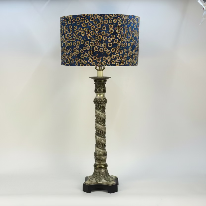 Decorative table lamp with a floral-patterned shade on a white background